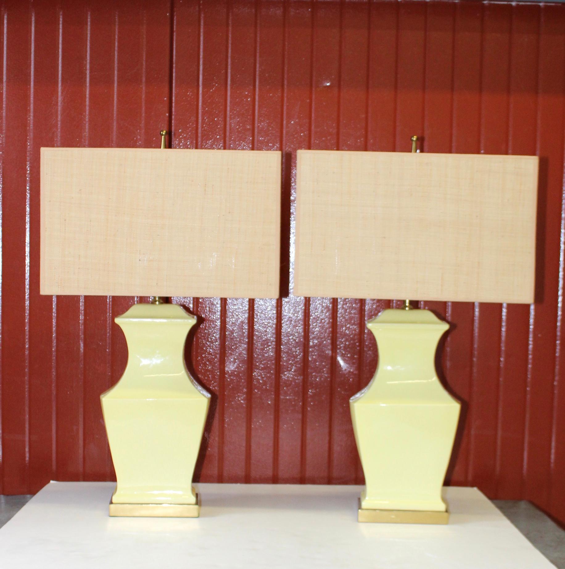 1960s modern yellow pottery with brass base and hardware table lamps.

Shades for photography only.

Height to light socket 21''.
