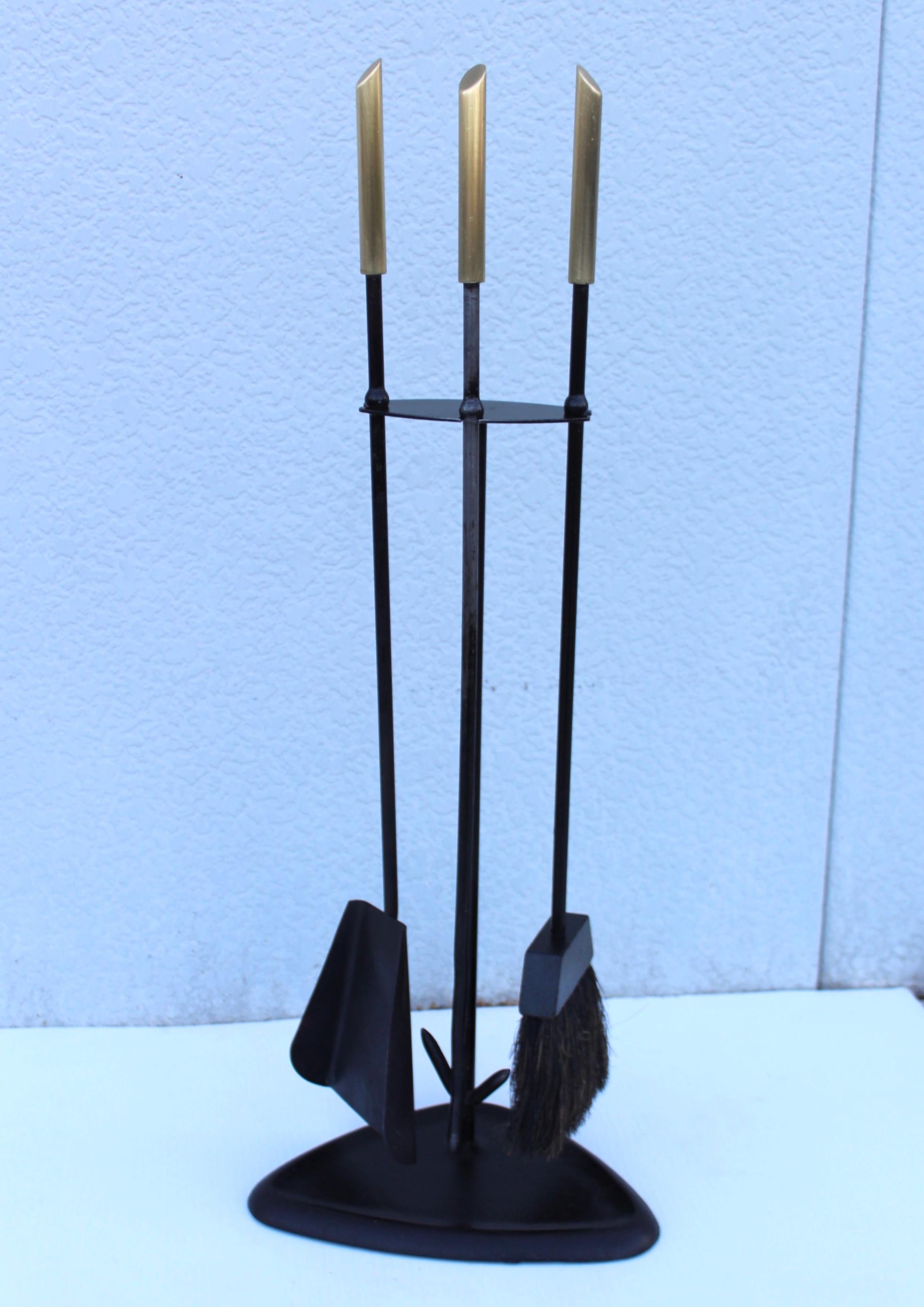 1960s modernist brass and iron fireplace tools, in vintage original condition with some wear and patina due to age and use.