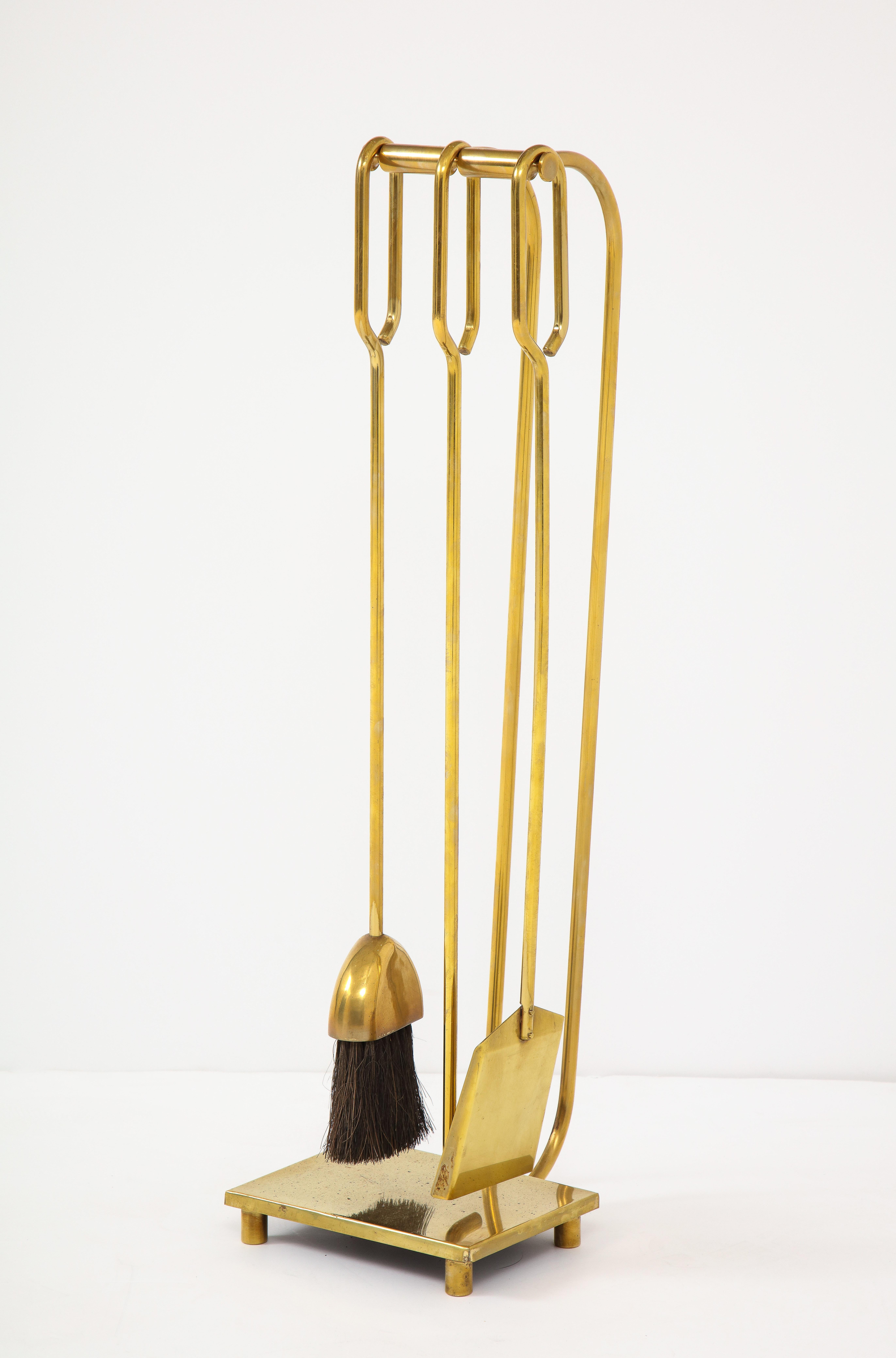 1960s modernist three-piece brass fireplace tools.