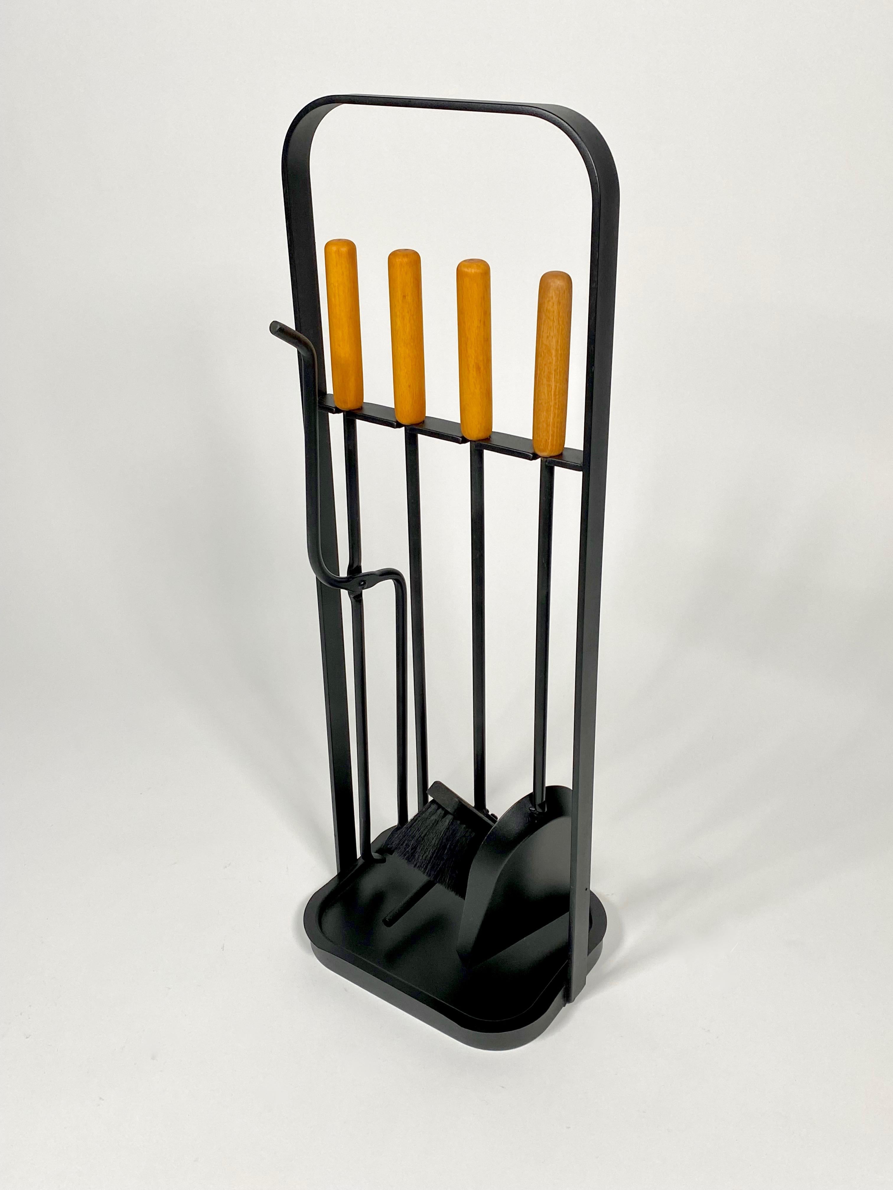 1960s Modernist fireplace tools the consist of a dust pan, brush, poker and log grabber, freshly painted black with amber colored beechwood handles, super clean design for many a fireplace. Can be used with or without catch tray on the holder,
