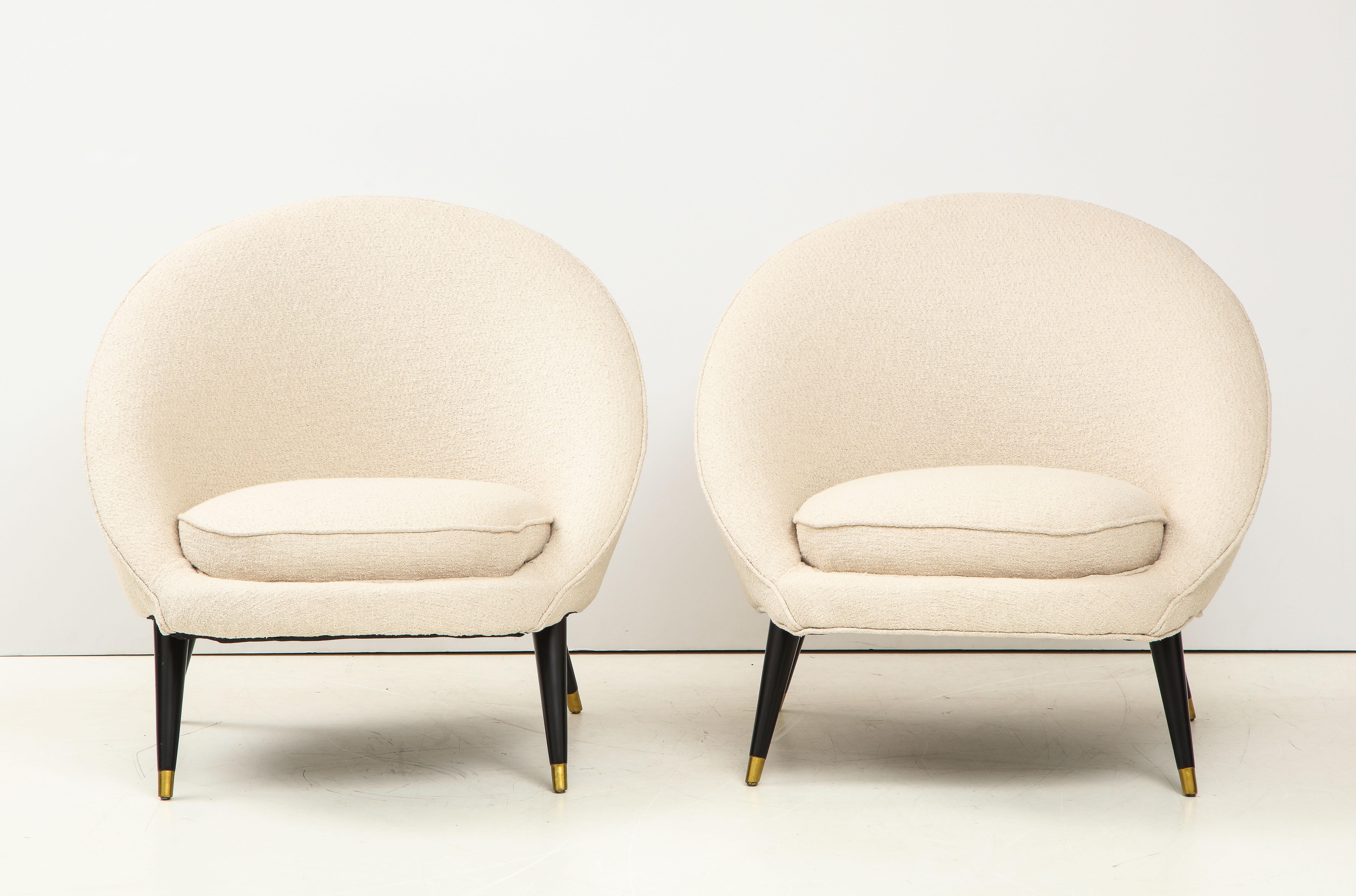 Stunning pair of 1960s modernist French lounge chairs, with black lacquered legs and gold detail newly reupholstered in Donghia fabric.