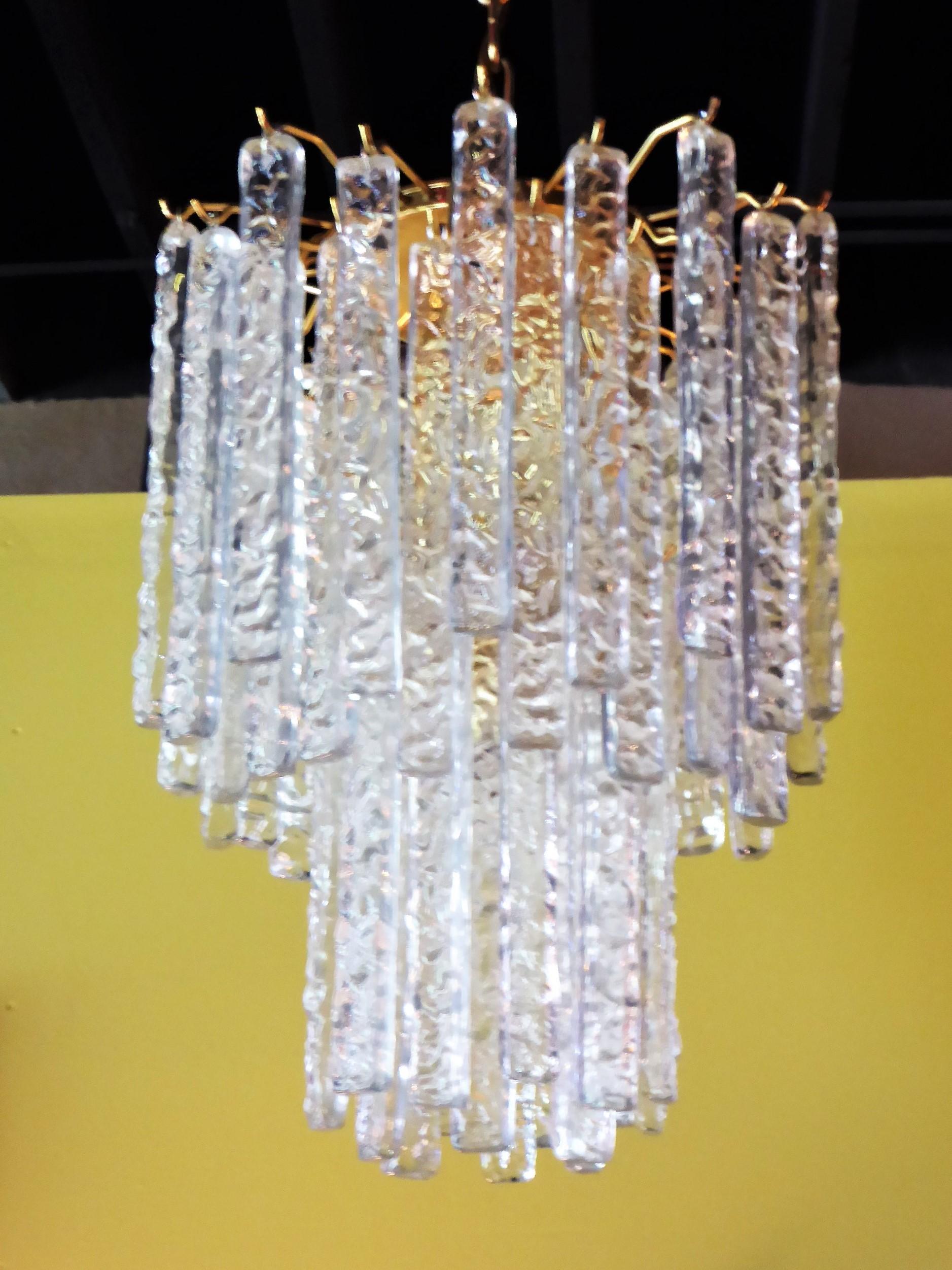 Reduced from $4,500.....Draped with 54 long textured Murano crystals, this 1960s Mazzega Chandelier beautifully has four inner lights and a strong, solid brass frame, chain and canopy. The four sockets take medium base bulbs.
Measurements: Fixture