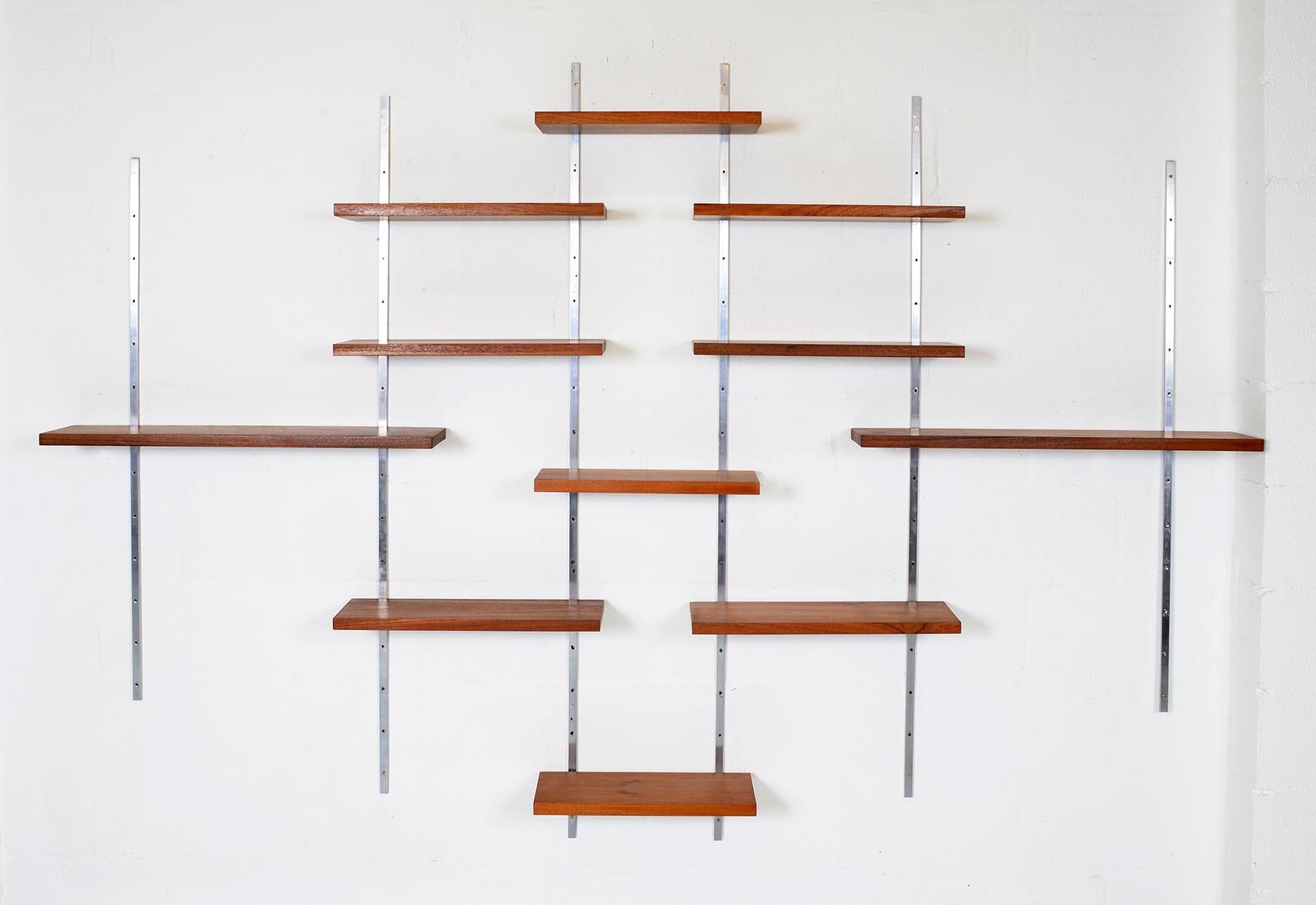 A wonderfully simple modernist design - this highly unusual 1960s modular shelving system looks like a piece of art! With chrome steel uprights and substantial solid teak shelving in three different sizes. Sourced from a single storey Modernist