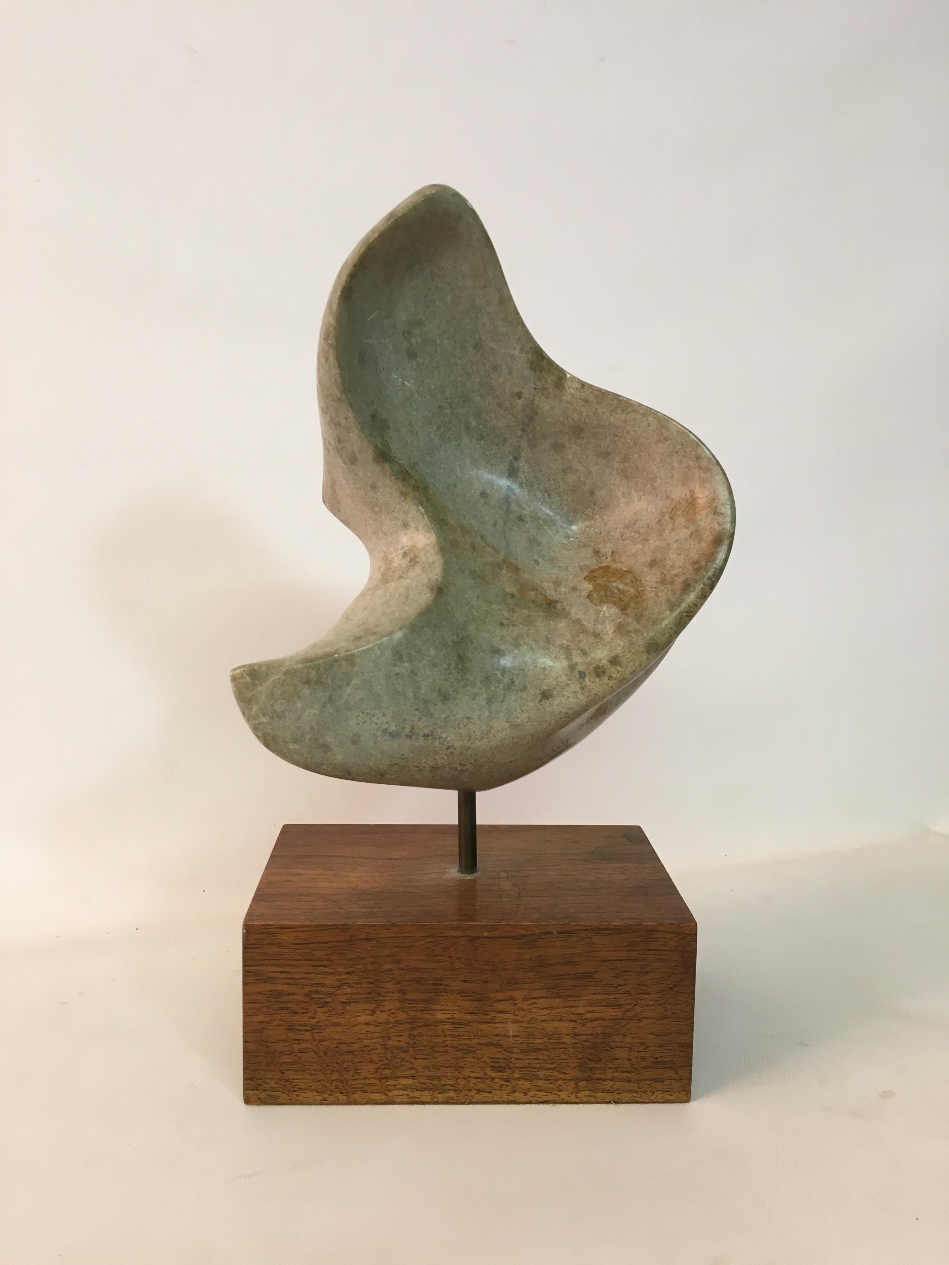 Supple and beautiful polished green marble sculpture, circa 1960. Mounted on a walnut block stand. Unsigned.

13.75