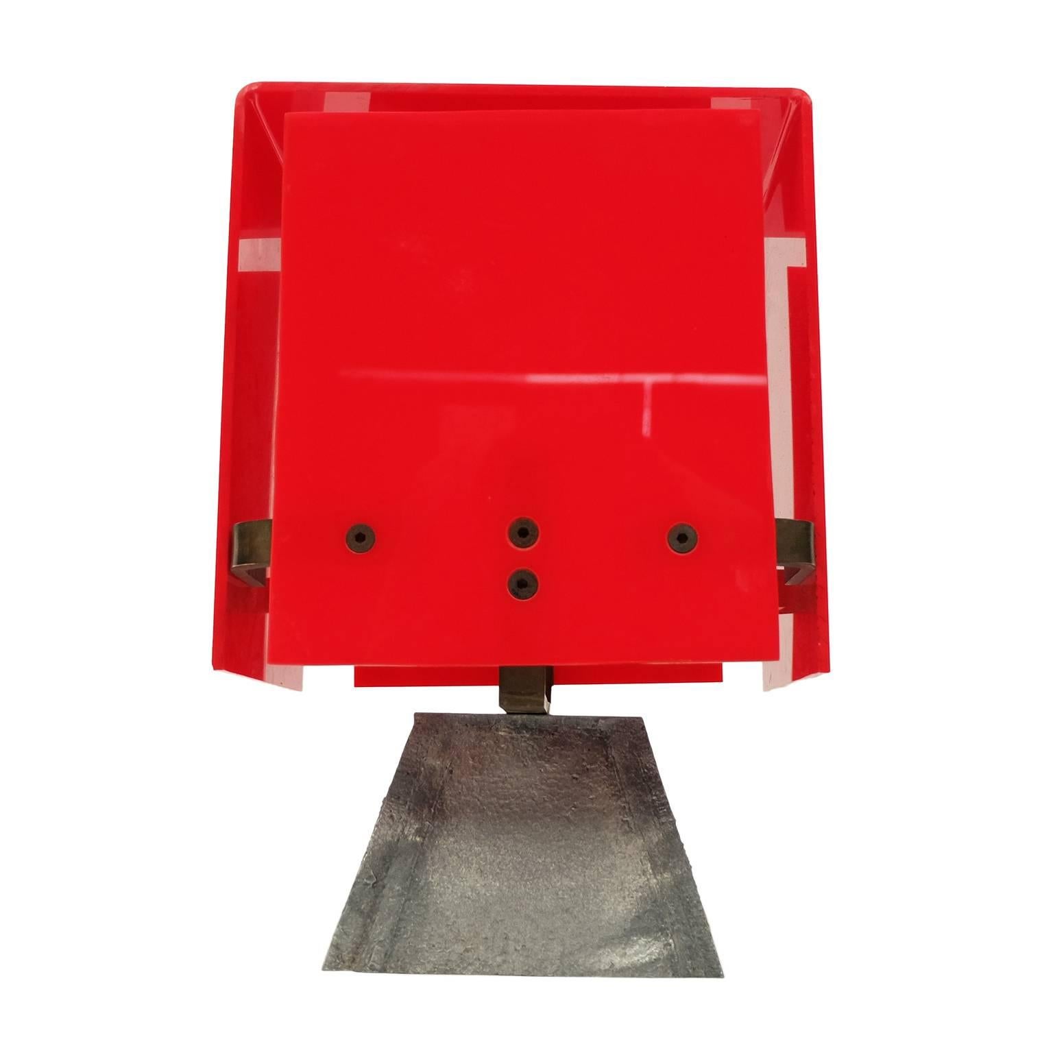 Unusual 1960s modernist table lamp designed and manufactured in England.

Brass frame and fitting with red acrylic shade. Cast alloy base.

  