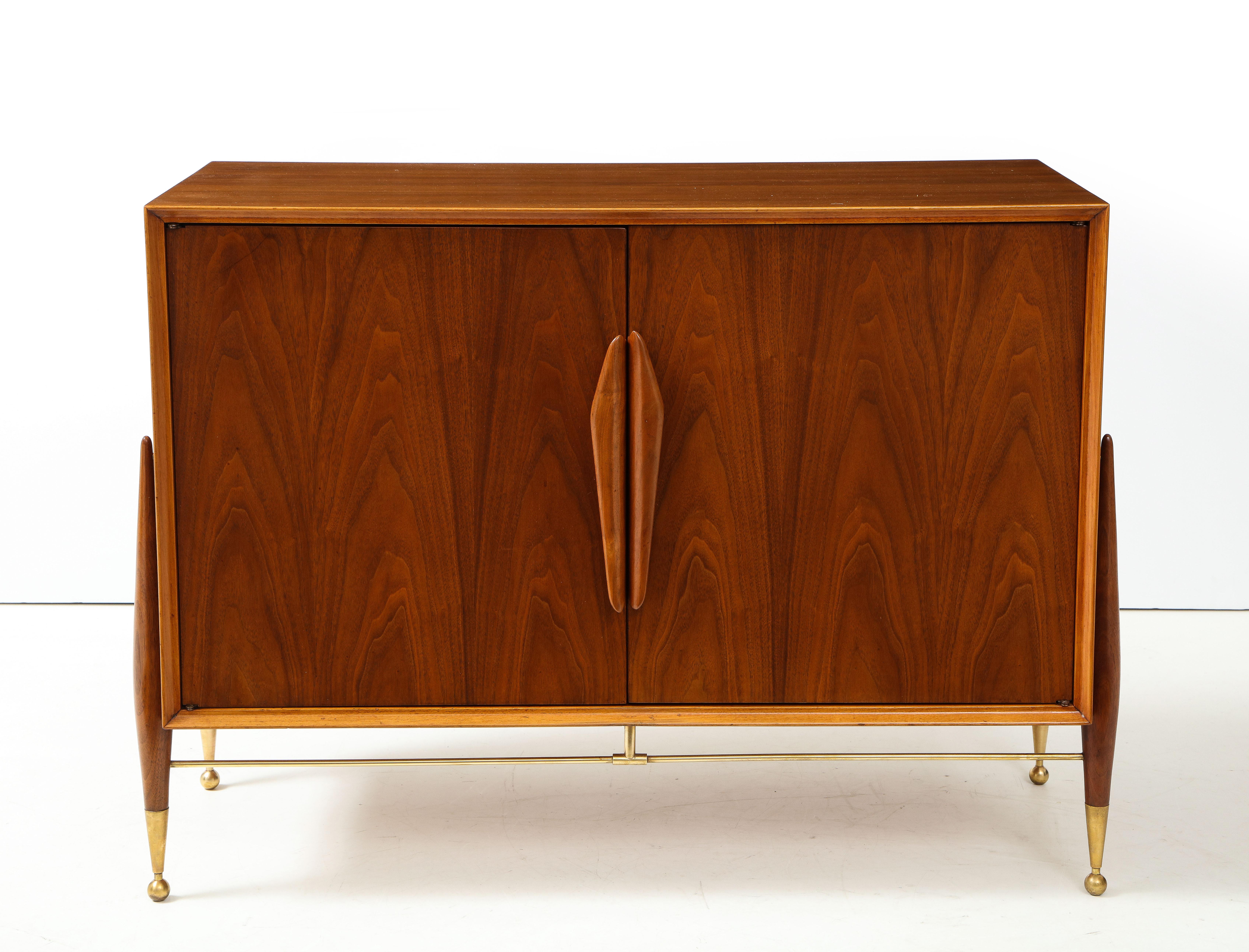 Stunning 1960's Mid-Century Modern walnut cabinet with solid brass legs and stretcher with two doors and adjustable shelf, fully restored with minor wear and patina due to age and use.