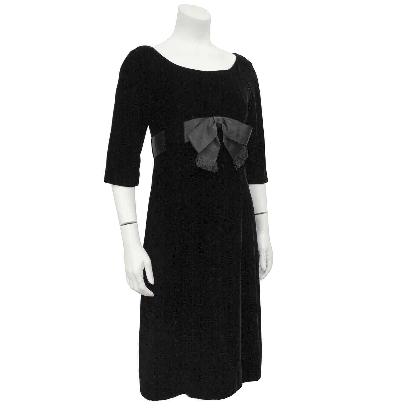 Early 1960's Mollie Parnis black velvet empire waist dress inspired by the Dior look dresses from the 60's. Scoop neckline, 3/4 sleeve, black satin wide ribbon sash with raw edged front bow fitted just below the bustline that overlaps the back