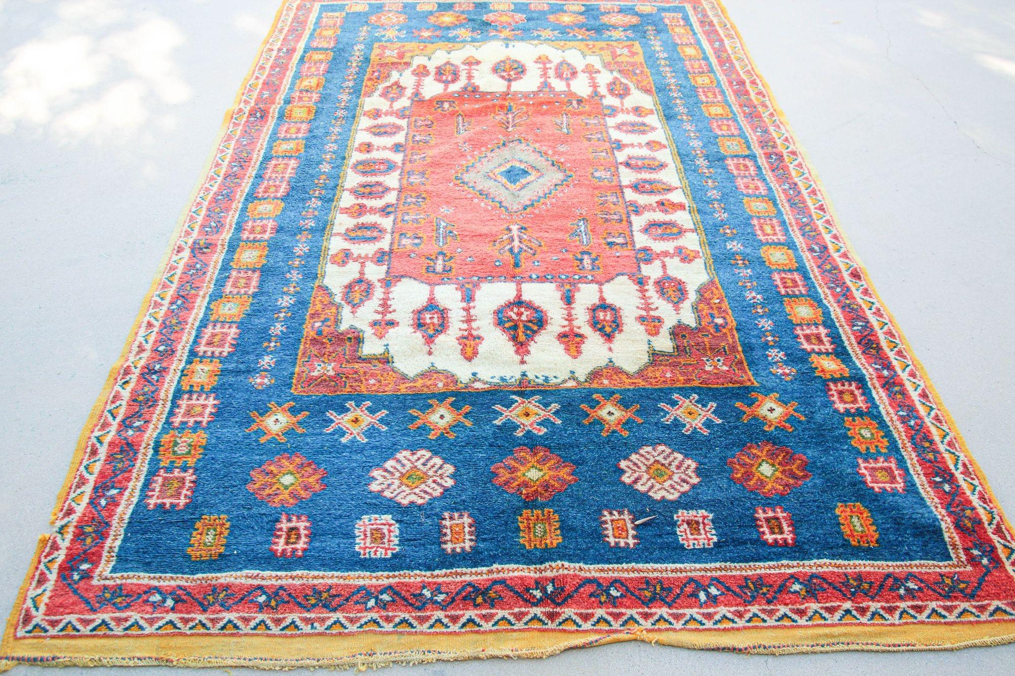 1960s vintage authentic Moroccan Berber Rug in Orange Blue and Pink cors.For centuries the tribal people of Morocco's Atlas Mountains have passed down the delicate art of rug-weaving. In Northern Africa rugs are not only a practical asset to the