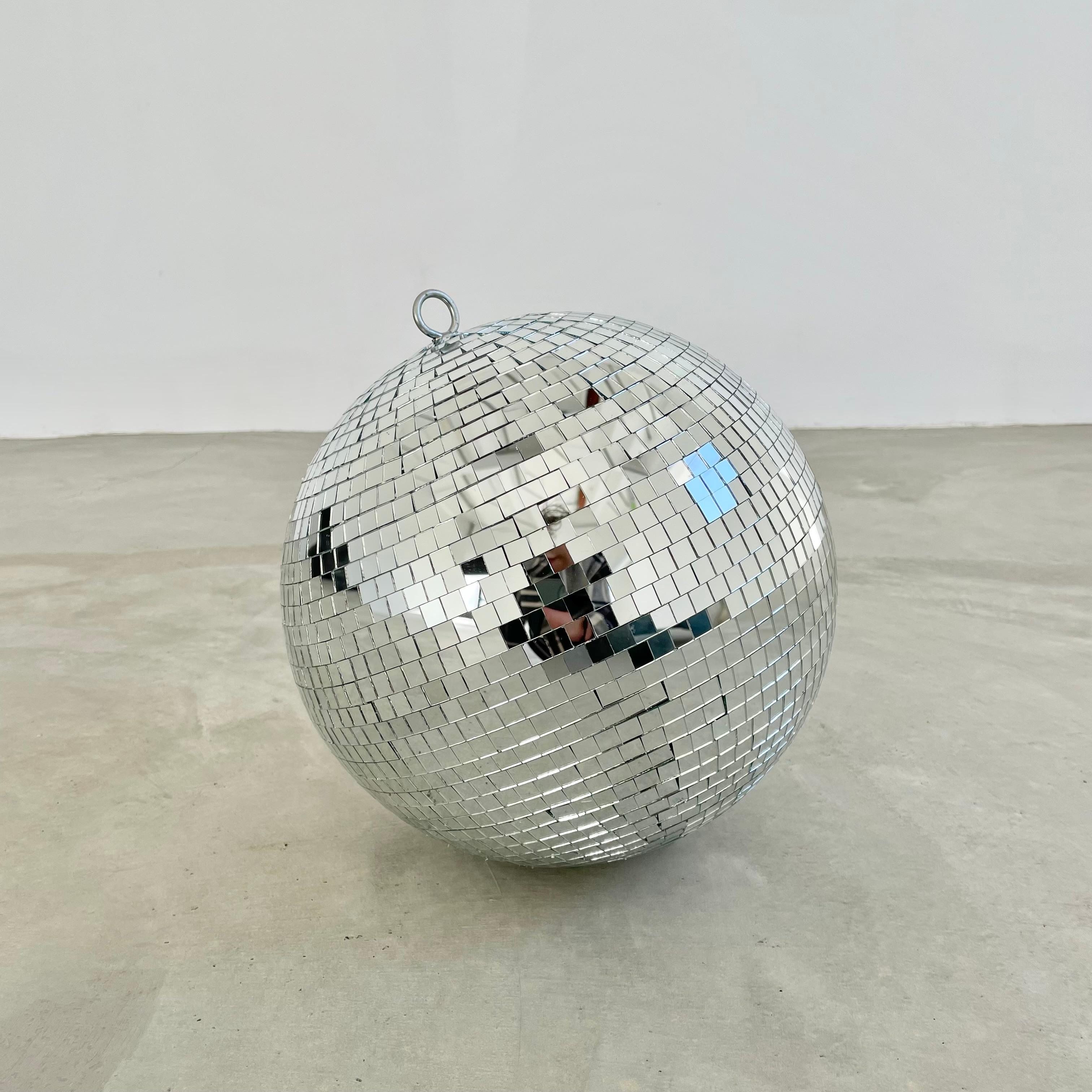 Great retro disco ball made out of individually cut square pieces of glass. Great condition. Illuminates beautifully. Has a metal ring at the top to connect to a string, rope or chain. Great universal size and presence. No chips or cracks to glass
