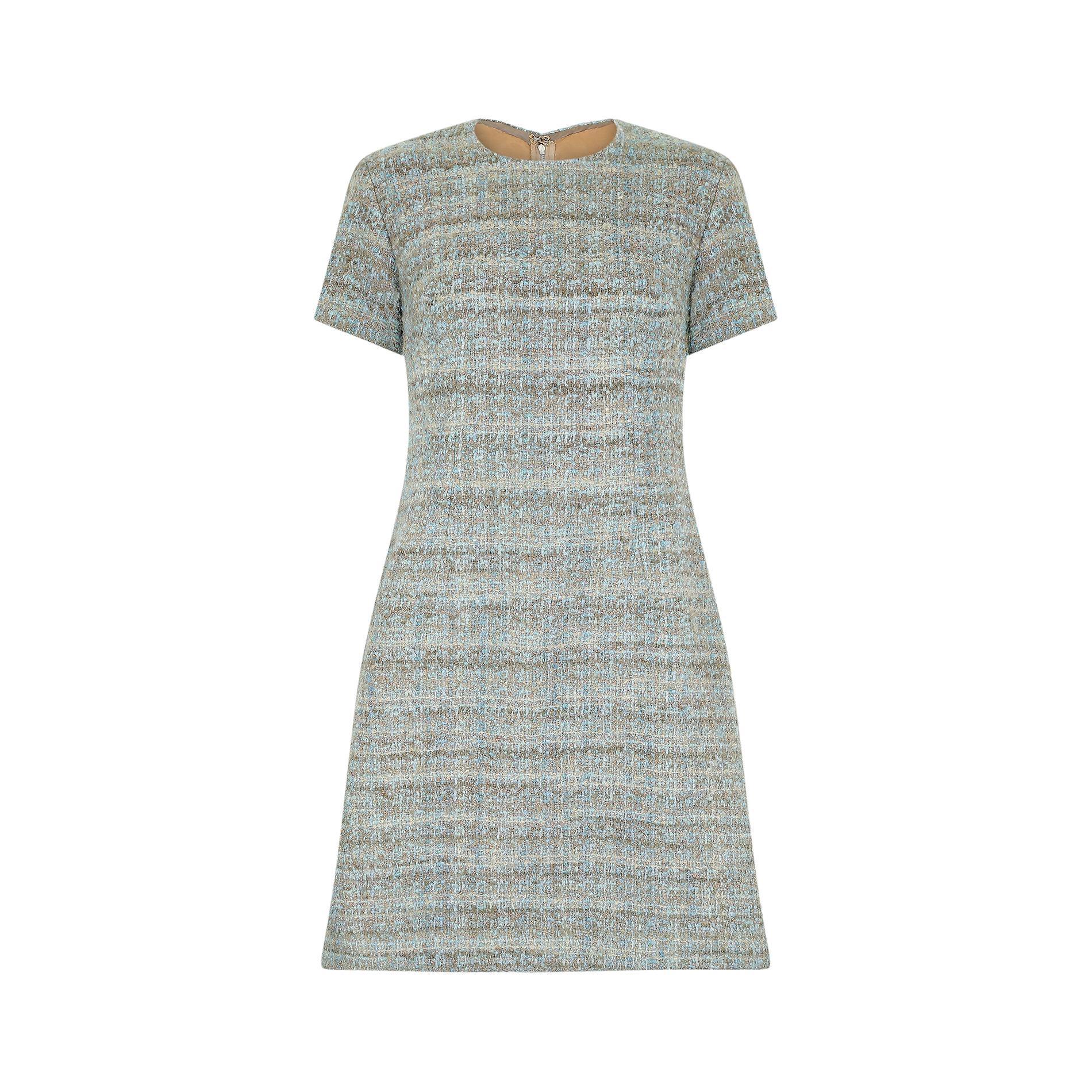 This French couture 1960s wool mod dress is cut in an era defining A-line silhouette, with short sleeves, a nipped in waist and slightly fuller skirt. It has a rounded neckline and a rear original zip closure, complete with hook and eye fastening.