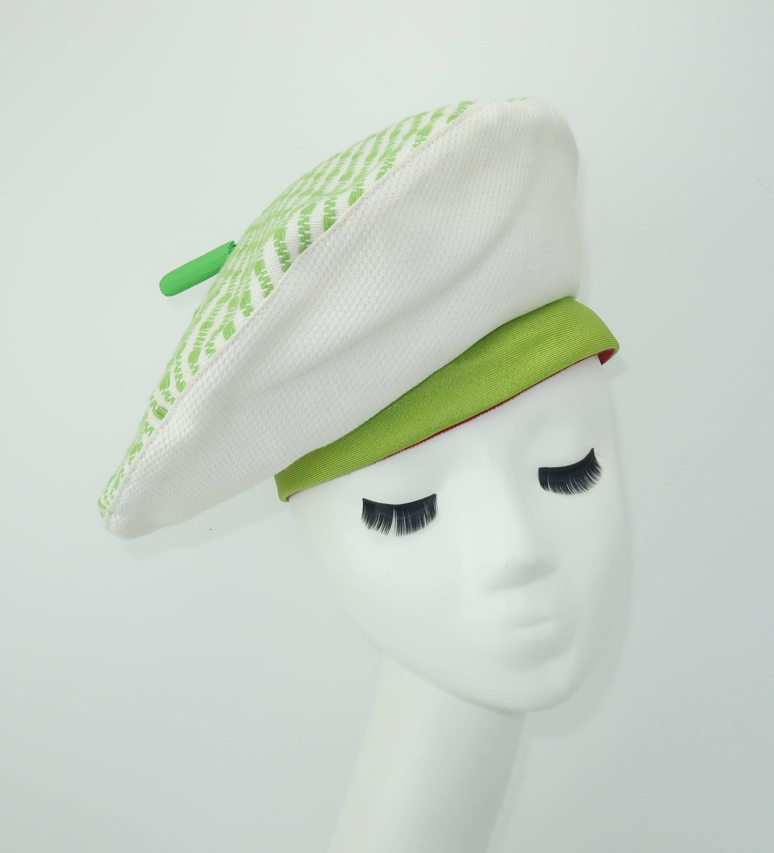 This whimsical beret designed by John Harberger for his millinery line, Mr. John Classic, has a crisp summery aesthetic.  The white cotton pique body is decorated with a bright green rim, a textured green pattern at the crown and a 2.25