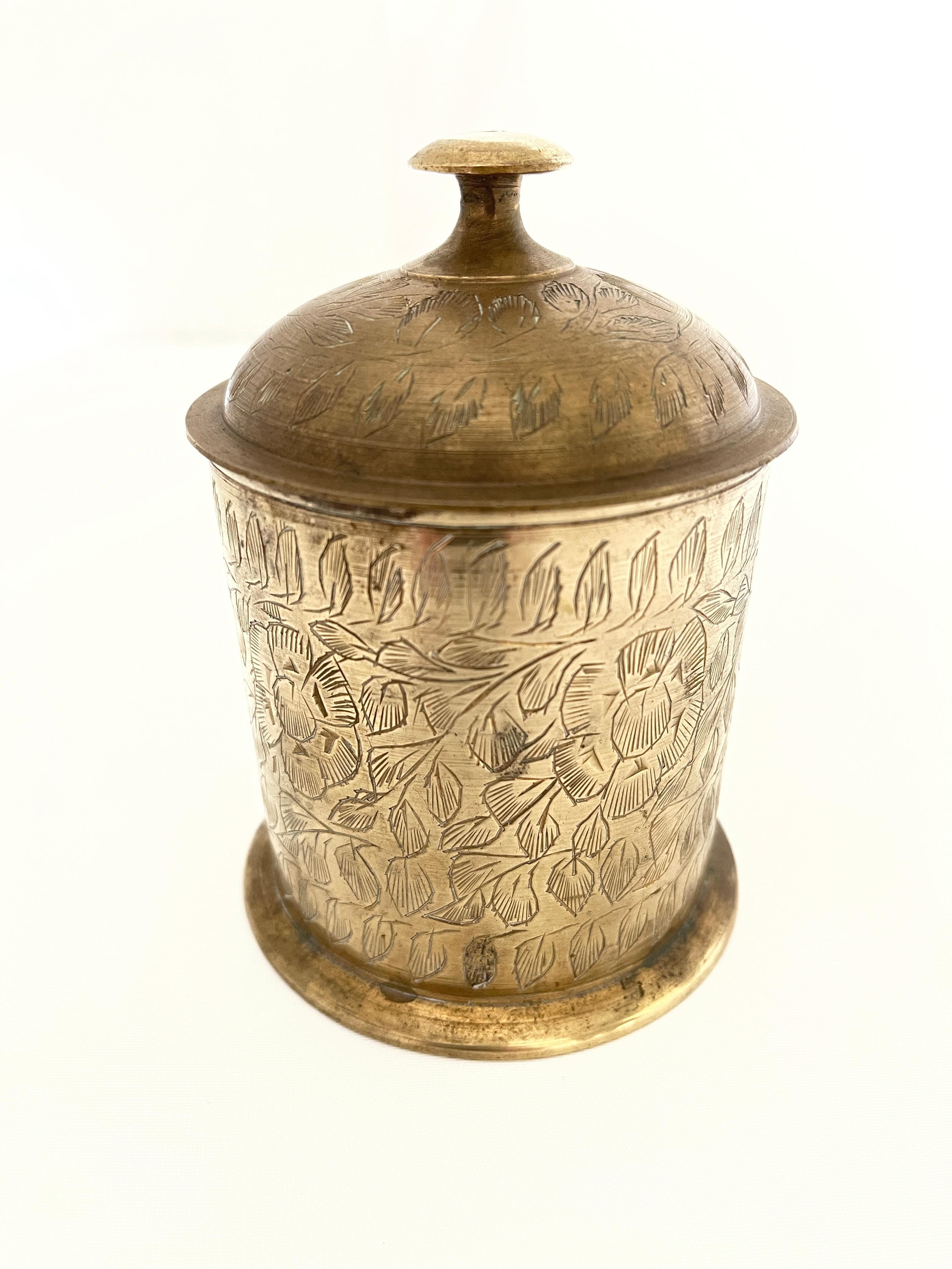 Indian brass lidded cigarette holder / trinket box, with hand engraved Mughal floral designs all around. Completely hand wrought piece with exquisite detail. Hand crafted in India, c. 1960's.