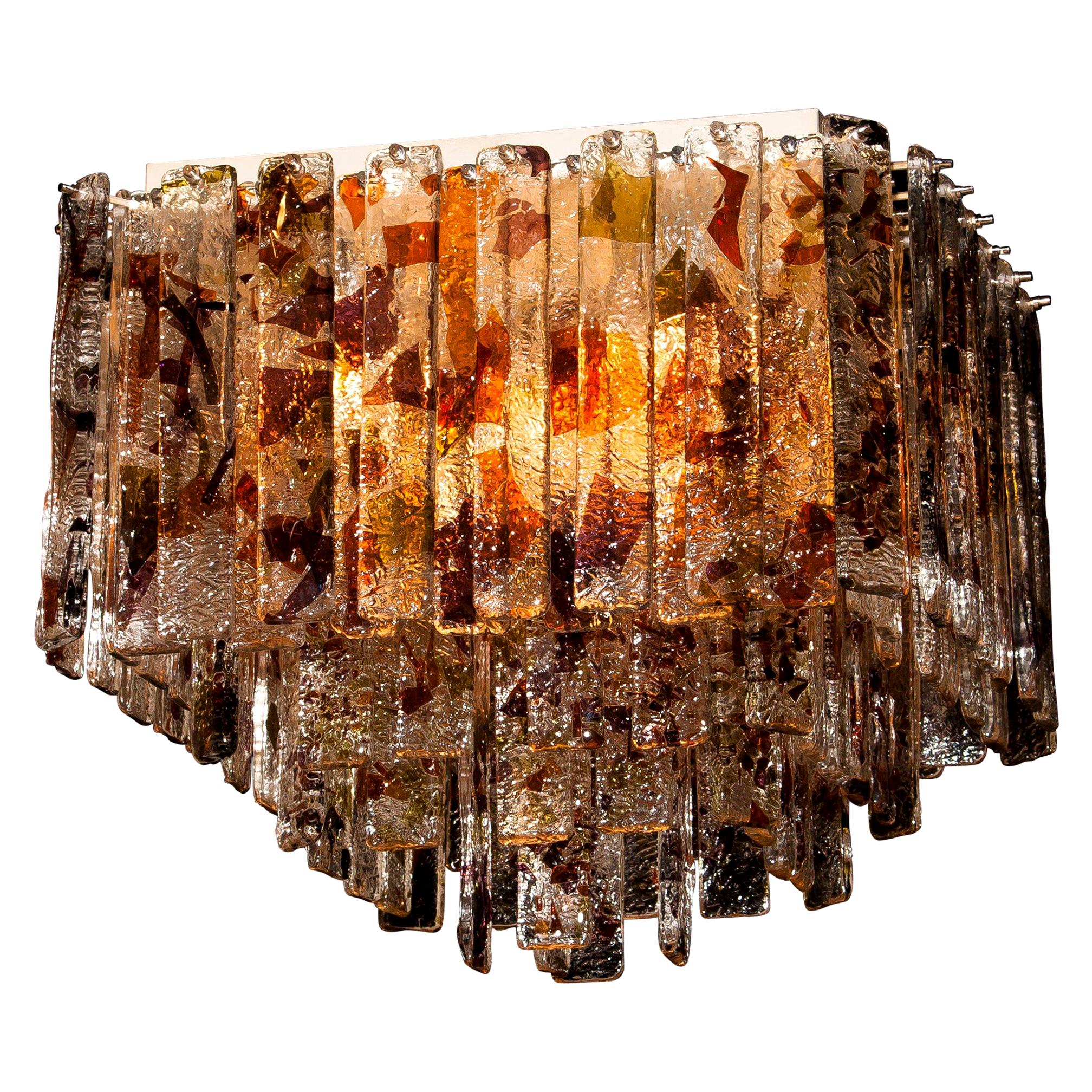 Stunning Italian Mid-Century Modern squared ceiling lamp by Mazzega.
95 pieces of clear crystal elements measuring: 28 cm each.
The glass hangs on hooks and pins on to a white lacquered metal frame, as pictured.
The elements have three colors