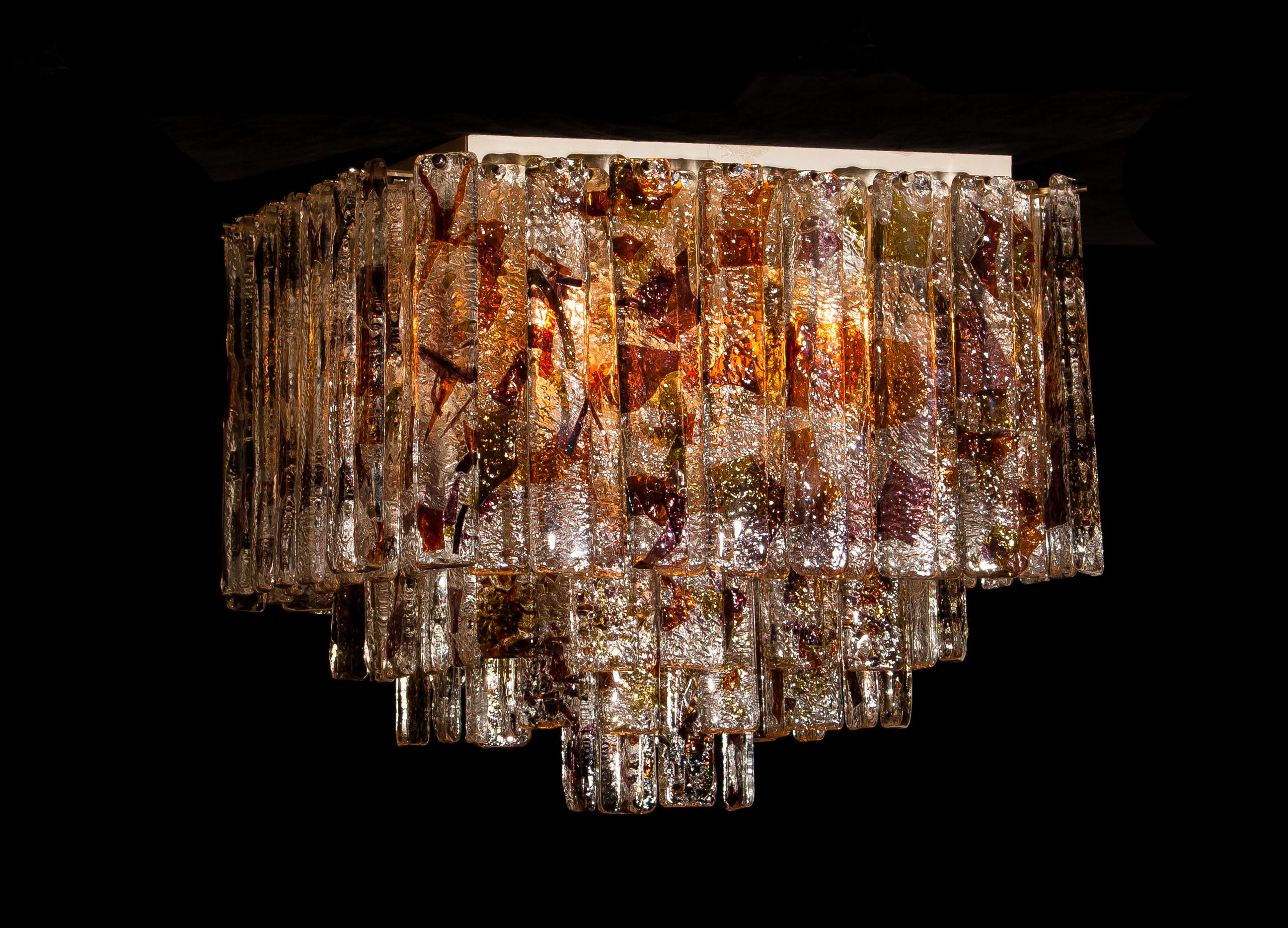 Stunning Italian Mid-Century Modern squared ceiling lamp by Mazzega.
95 pieces of clear crystal elements measuring: 28 cm each.
The glass hangs on hooks and pins on to a white lacquered metal frame, as pictured.
The elements have three colors