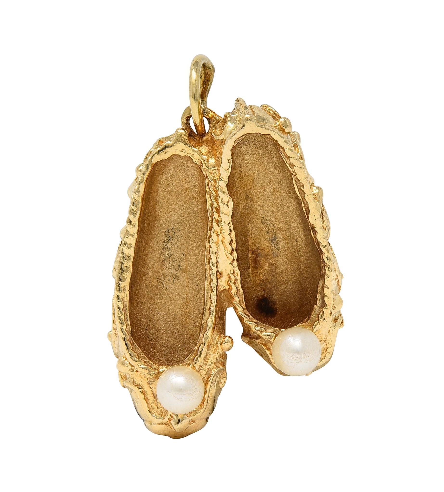 Designed as a dimensional slippers with grooved texture and filigree decoration
Accented by 3.0 mm round pearls on top - white with iridescence
Flush set with 2.5 mm round cut chrysoprase
Vibrant bluish green in color
Completed by jump ring