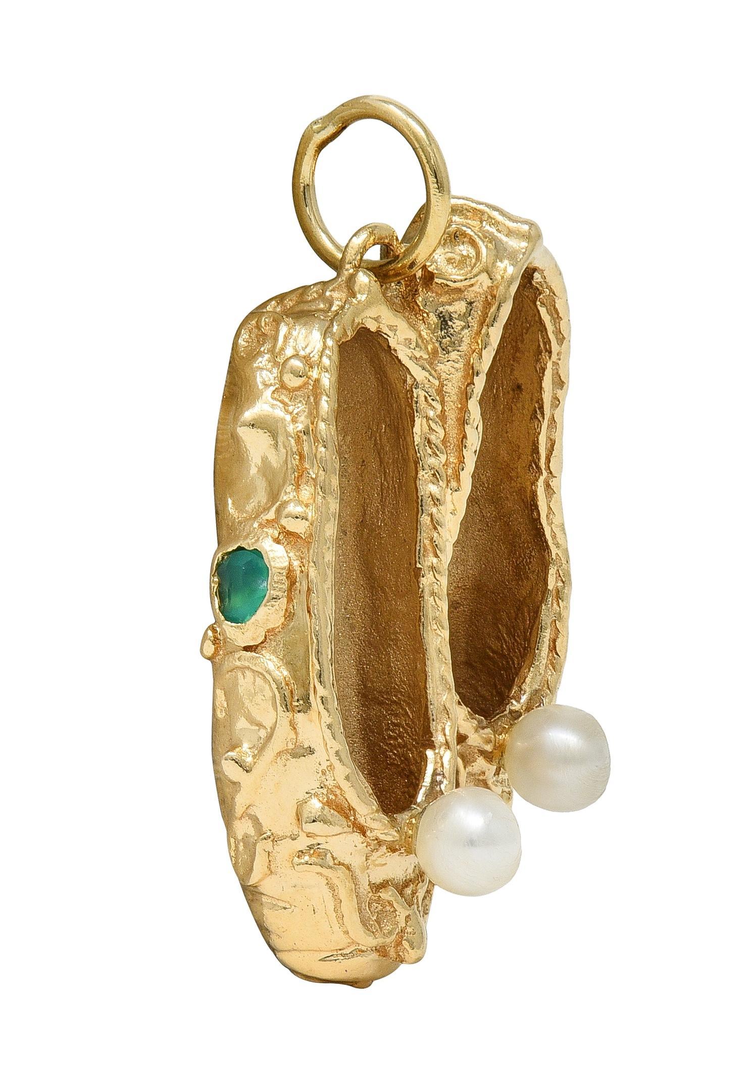 Designed as a dimensional slippers with grooved texture and filigree decoration
Accented by 3.0 mm round pearls on top - white with iridescence
Flush set with 2.5 mm round cut chrysoprase
Vibrant transparent bluish green in color
Completed by jump