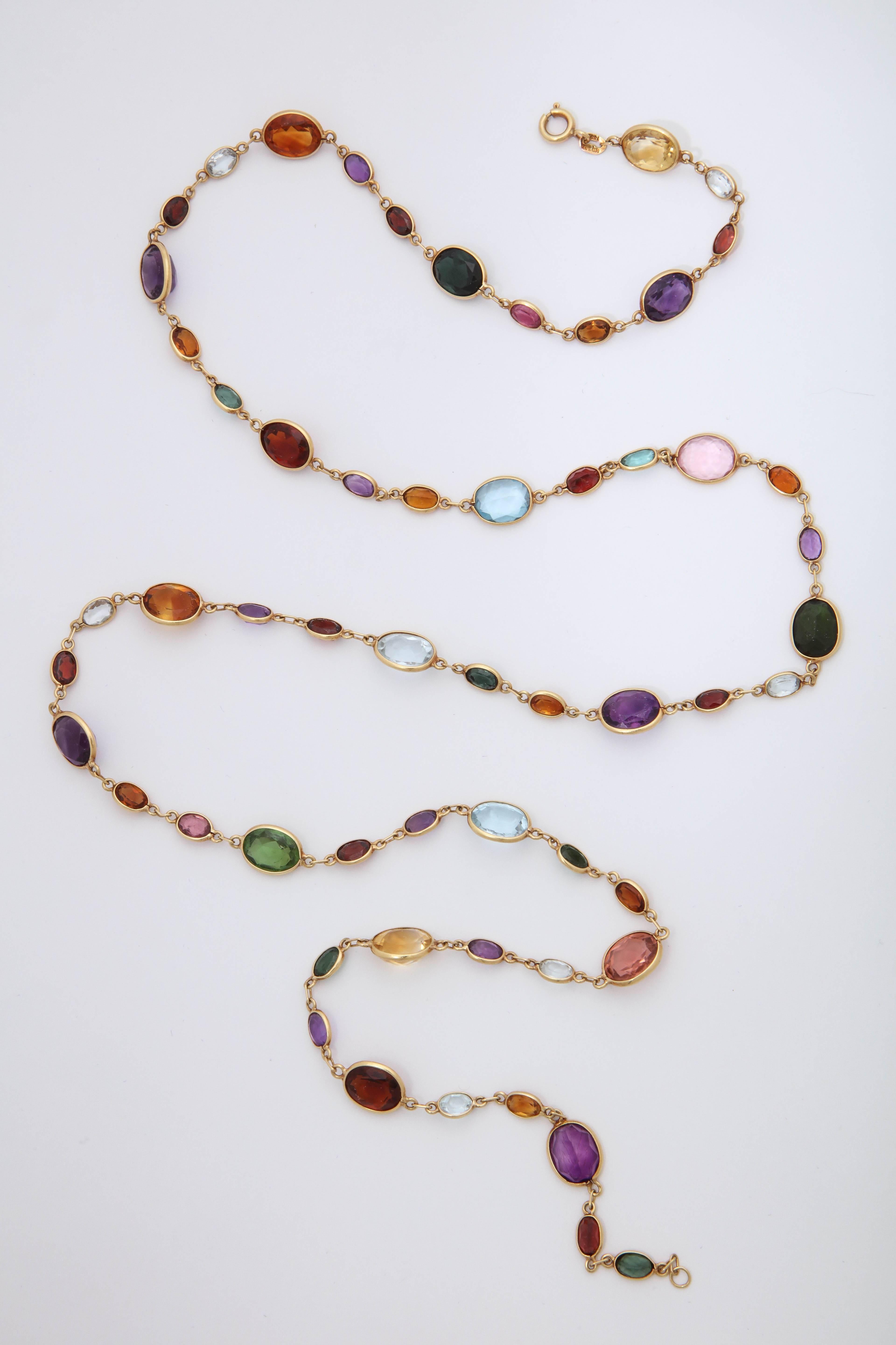 One Ladies 18kt Gold Long Chain Necklace Designed With Bezel Set Oval Cut Aquamarines, Green Tourmalines,Citrines, Pink Kunzites Amethysts And Garnets. 31 Inches Long May Be Worn Doubled. Created In The 1960's In The United States Of America.All