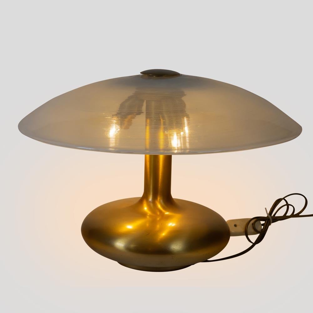 An Italian design table light, brass metal base, Venini blown glass shade. 1960's.