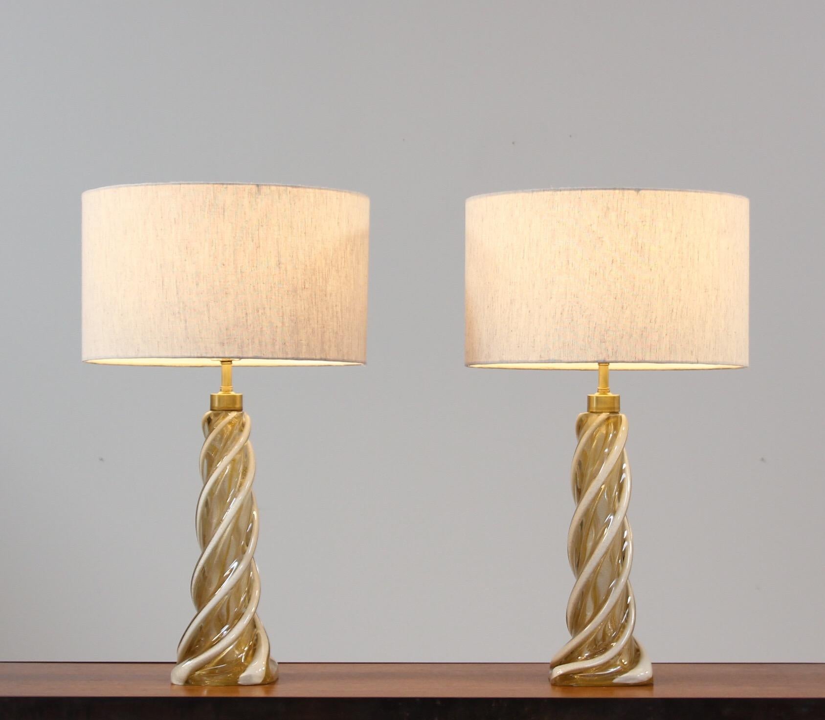 Spectacular pair of 1960s Murano glass lamps executed in a beautiful pattern consisting of white and gold flecked swirls by Seguso Vetri D’Arte. Both lamps are in excellent condition with no chips or cracks. 

If you’re in search of that special