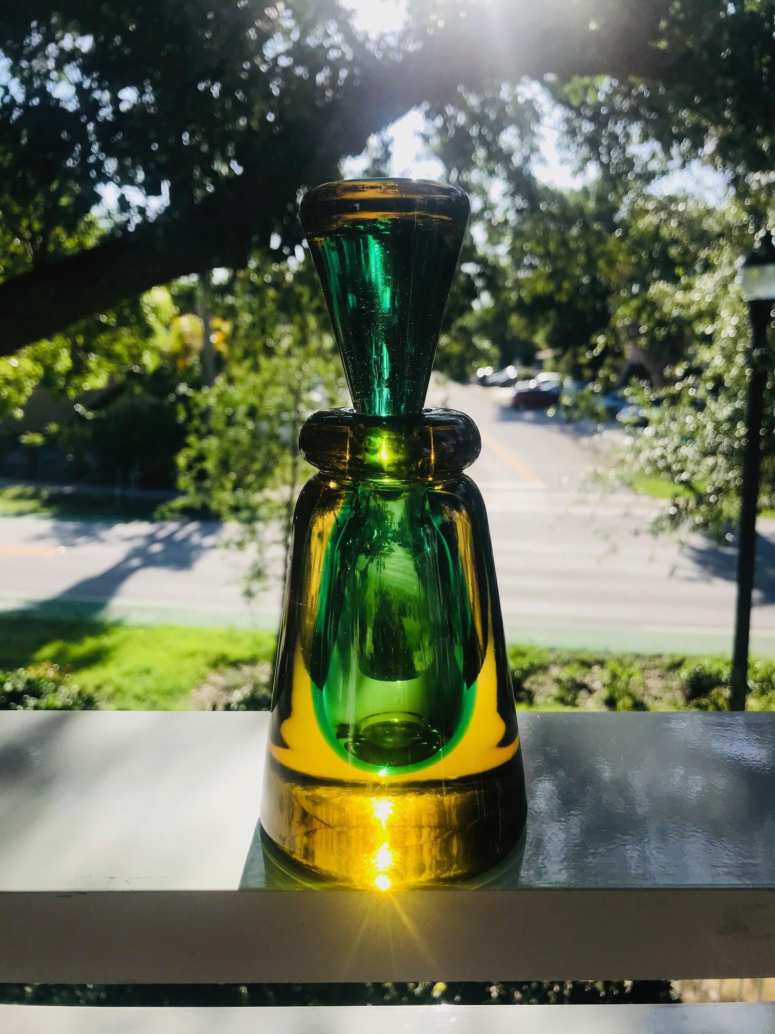 Mid-Century Modern decorative bottle or vintage perfume bottle in vibrant hues of emerald green and golden yellow. Beautifully handcrafted with Sommerso technique featuring a tapered stopper with green glass submerged into a blown yellow glass