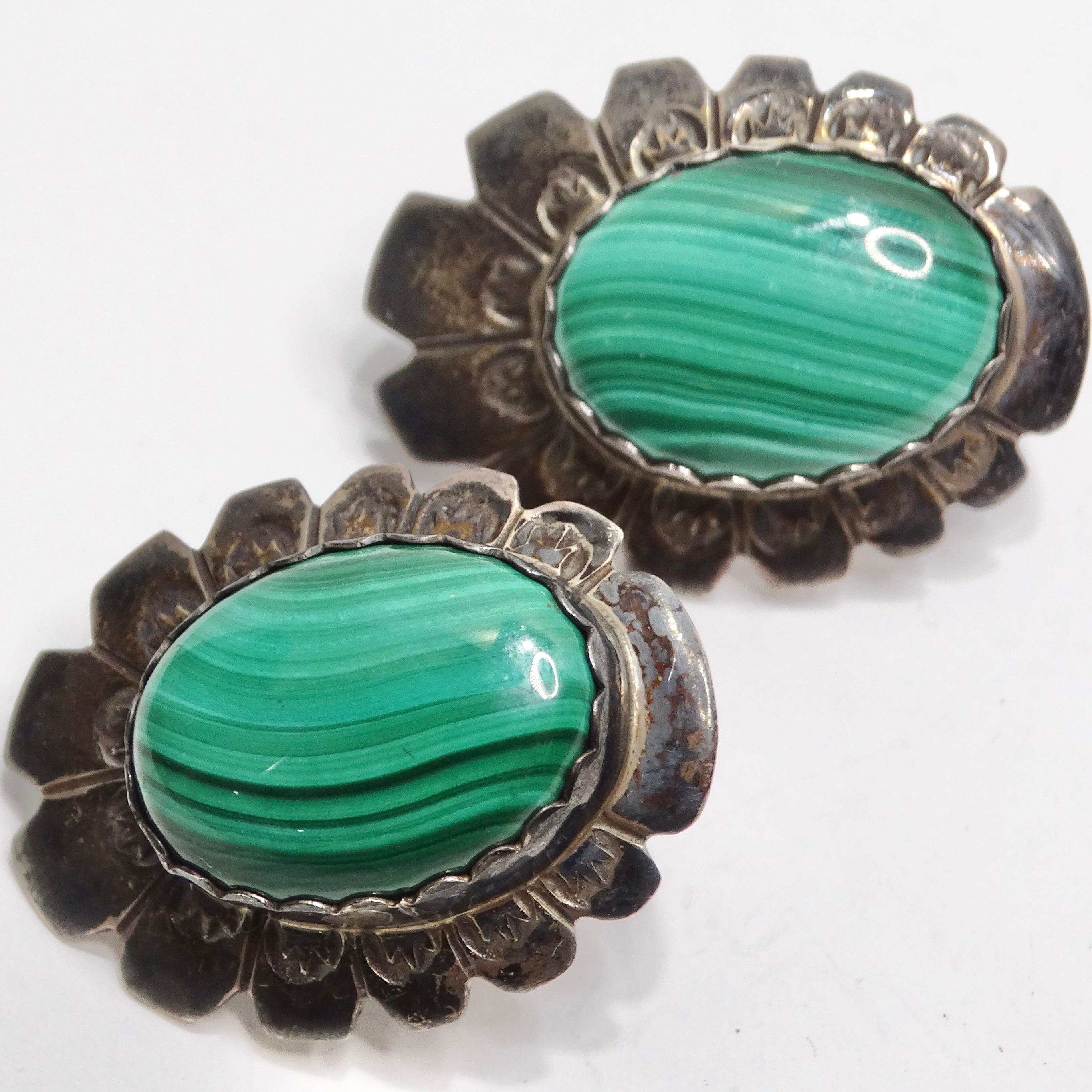 Introducing the 1960s Native American Silver Malachite Earrings—a pair of stunning flower-shaped earrings that seamlessly blend Native American craftsmanship with a timeless and vibrant design. These earrings are not just accessories; they are