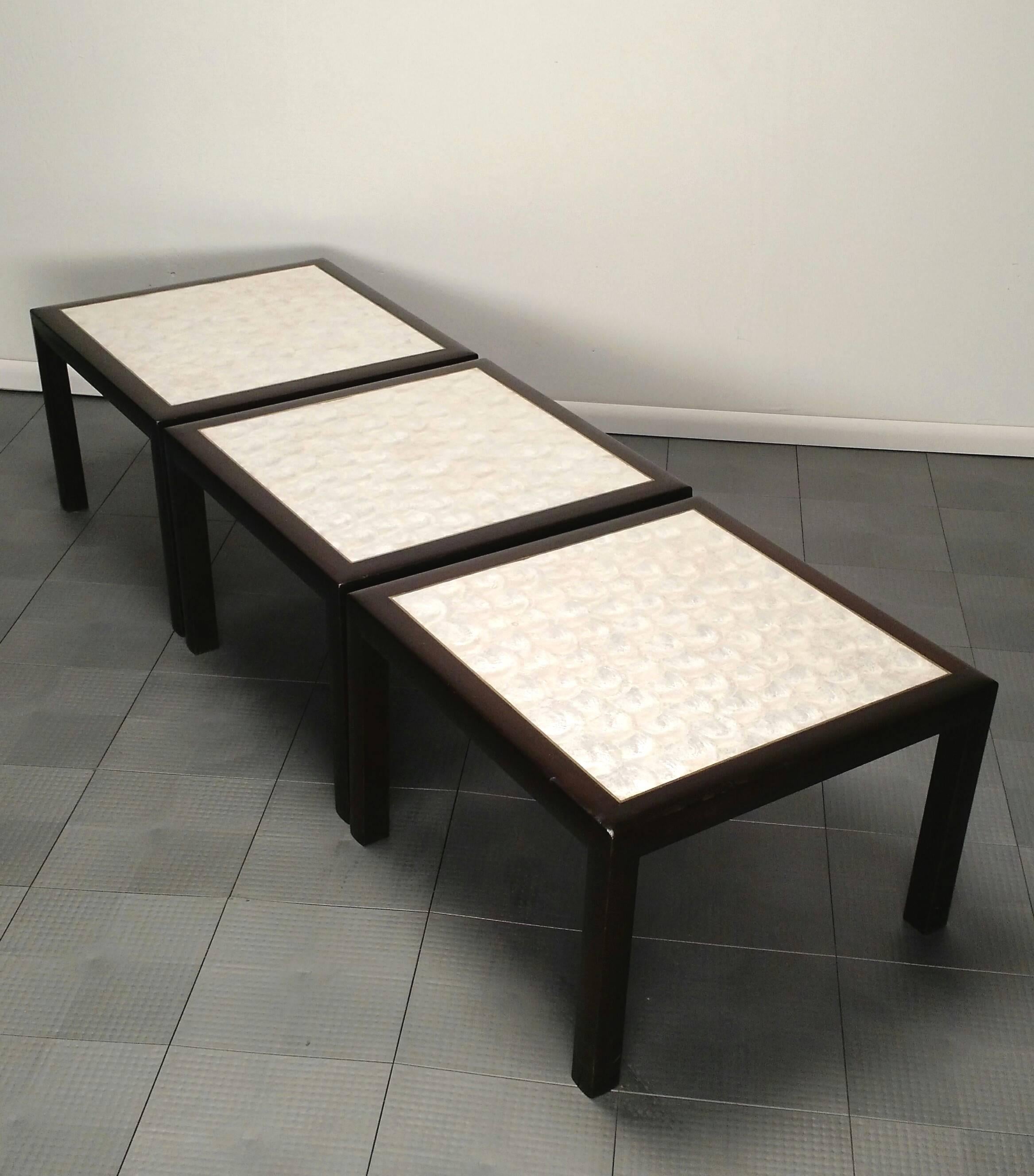 Set of three lacquered mahogany parsons tables with polished brass top trim and pearly Capiz shell inlay.
Can be used together as a long cocktail table or individually.
Extraordinary custom crafted tables, circa 1960s.
These are in exceptional
