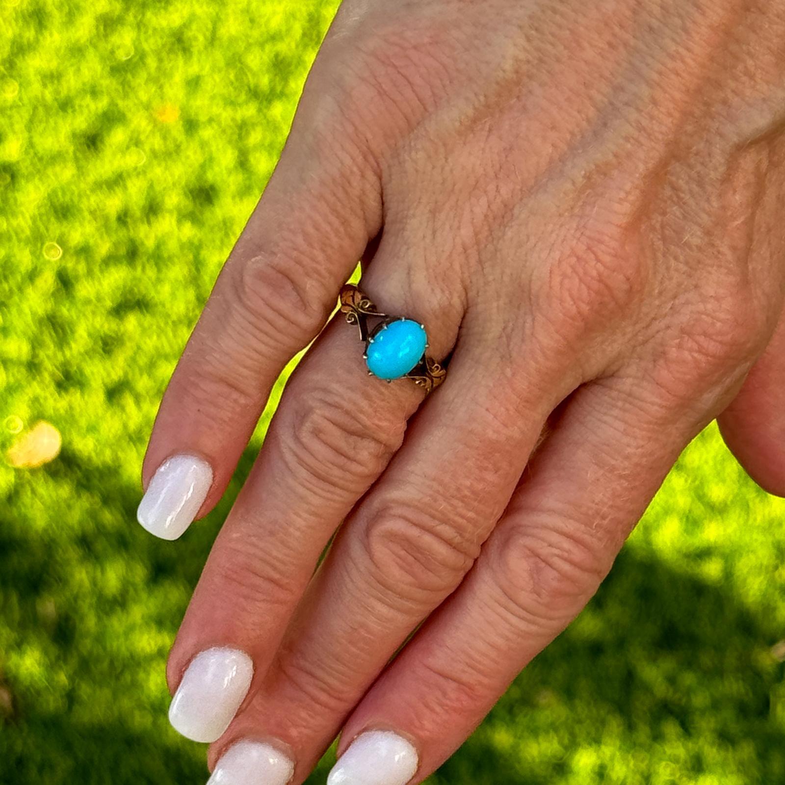 Beautiful vintage turquoise ring fashioned in 18 karat yellow gold. The ring features a cabochon natural turquoise gemstone set in a handcrafted vintage mounting. The ring is currently size 5.5 (can be sized), and measures 6 x 10mm. Weight: 3.7