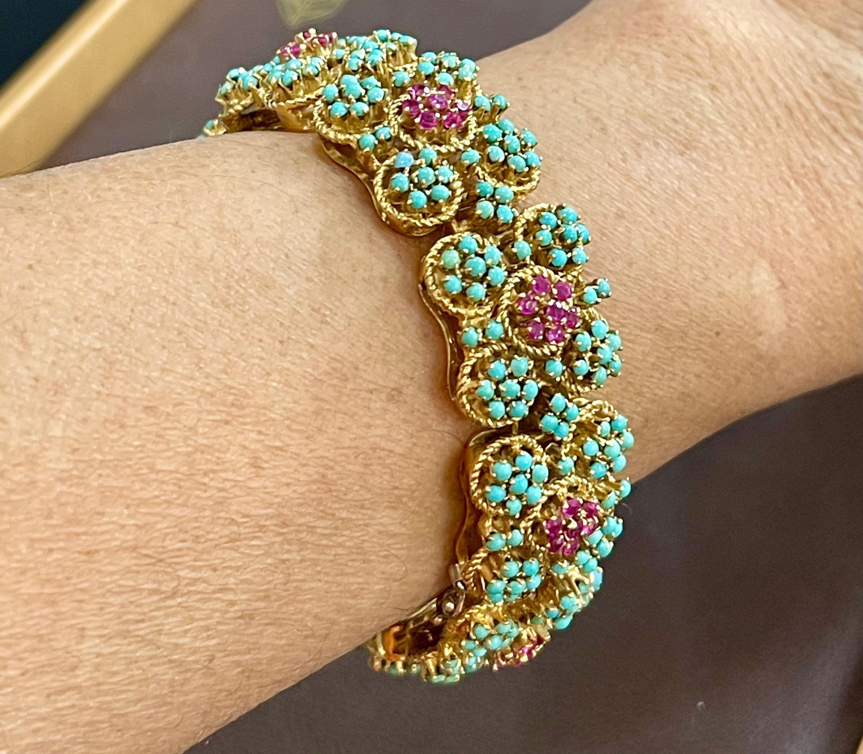 1960's Natural Turquoise & Ruby Bangle /Bracelet in 18 Kt Yellow Gold 72.6 Grams
A flexible Italian  bangle bracelet from our Estate collection is bright with 342 round turquoise cabochons in decorative stations. 9 portions total and each portion