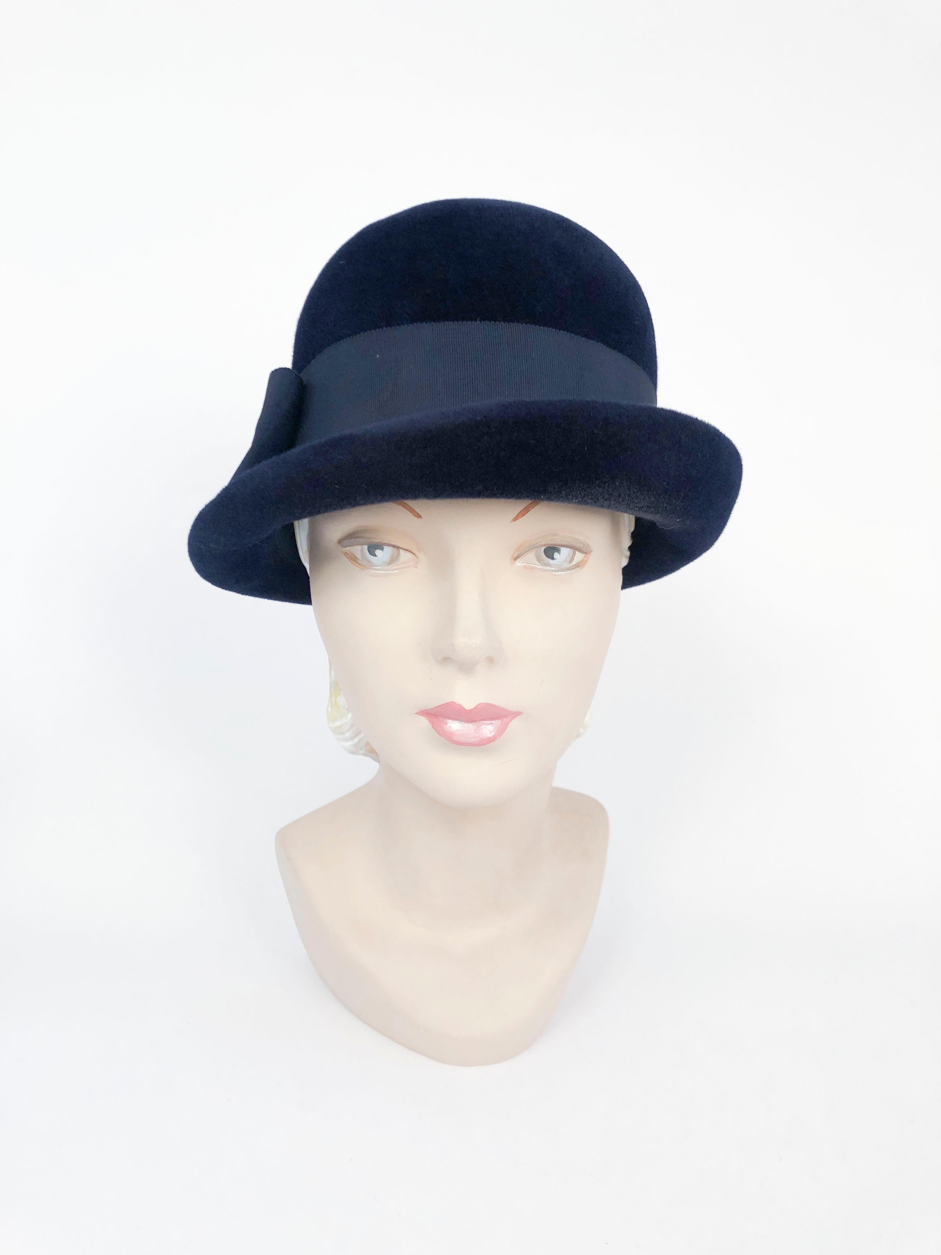 1960s Navy Fur Felt Cloche with Wide Band and Bow finished with a single brass button.
