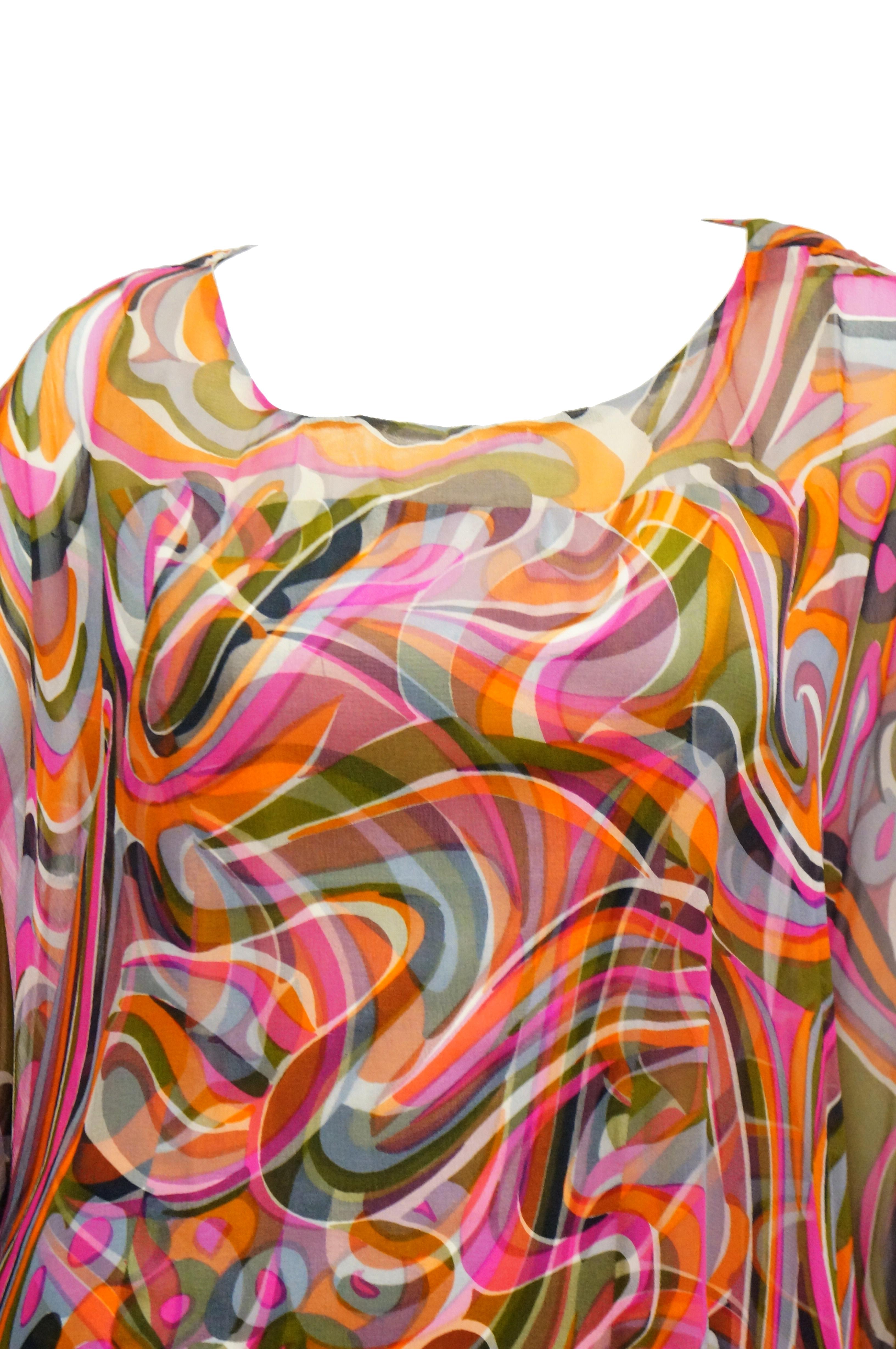 Amazing two layer dress with brilliant pink, green, cream, and blue swirling pattern! This dress features a somewhat fitted silk dress with wide round neckline, wide straps, a slightly contoured waist, and a maxi length skirt. The top layer of the