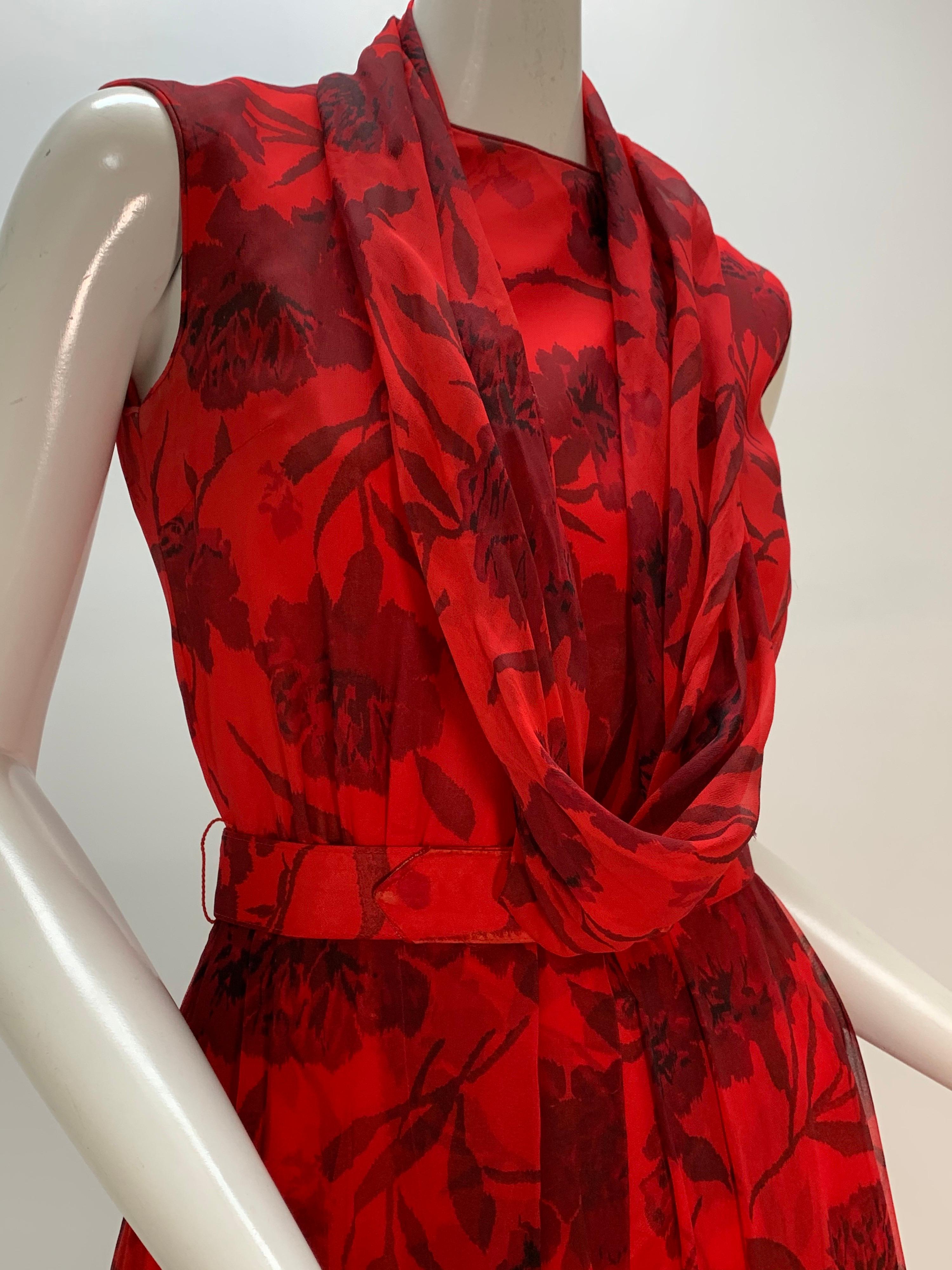A charming 1960s Nelly Don red and black carnation print chiffon sleeveless cocktail dress with a detached draped cowl collar. Fitted bodice, full skirt. Original belt included. Zip in back. 