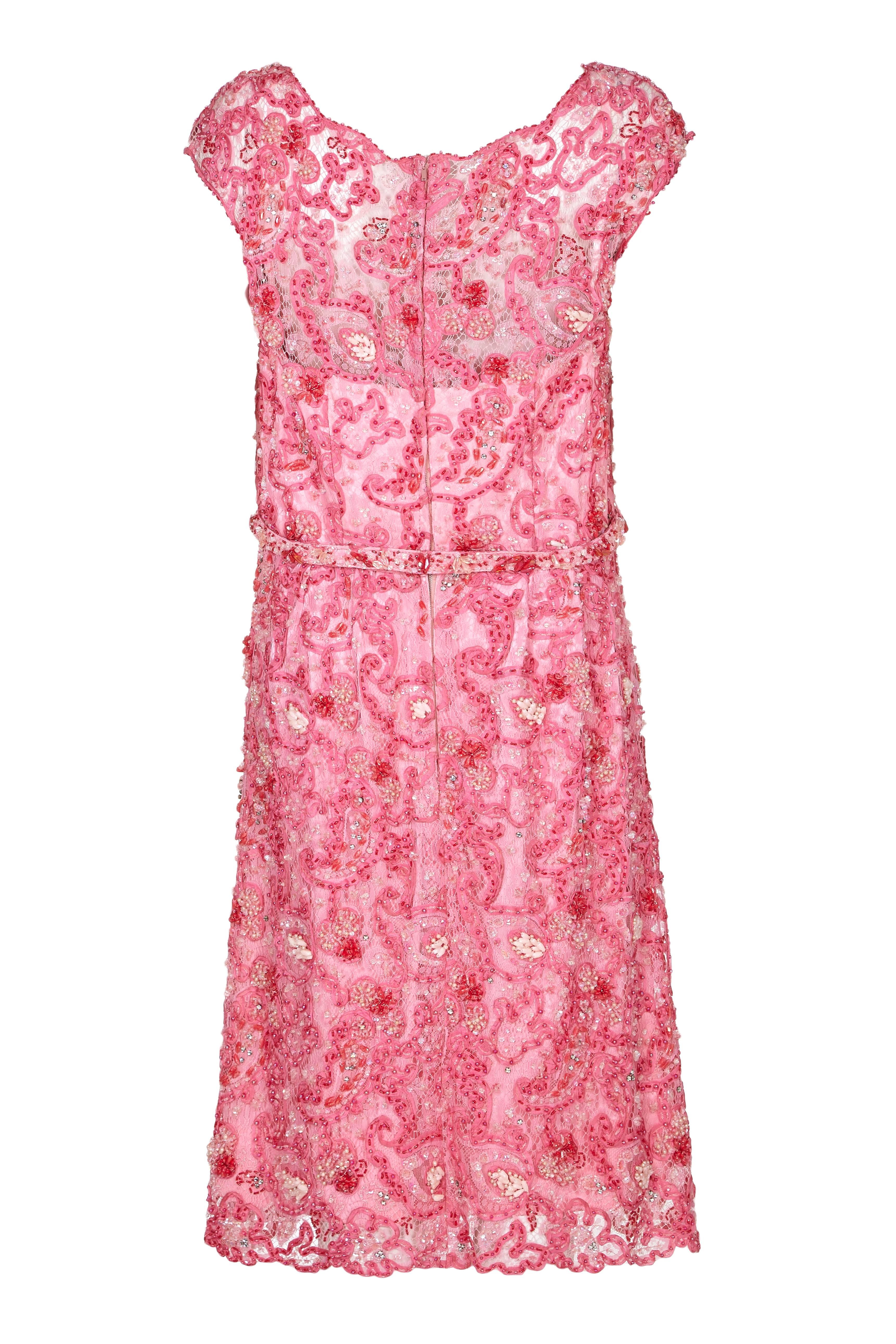 Fabulous vintage 1960s dress by London couturier Norman Hartnell, originally owned by Dame Barbara Cartland.  A really incredible couture dress with an over layer of pink lace which is lavishly and beautifully beaded in varying shades of pink. 