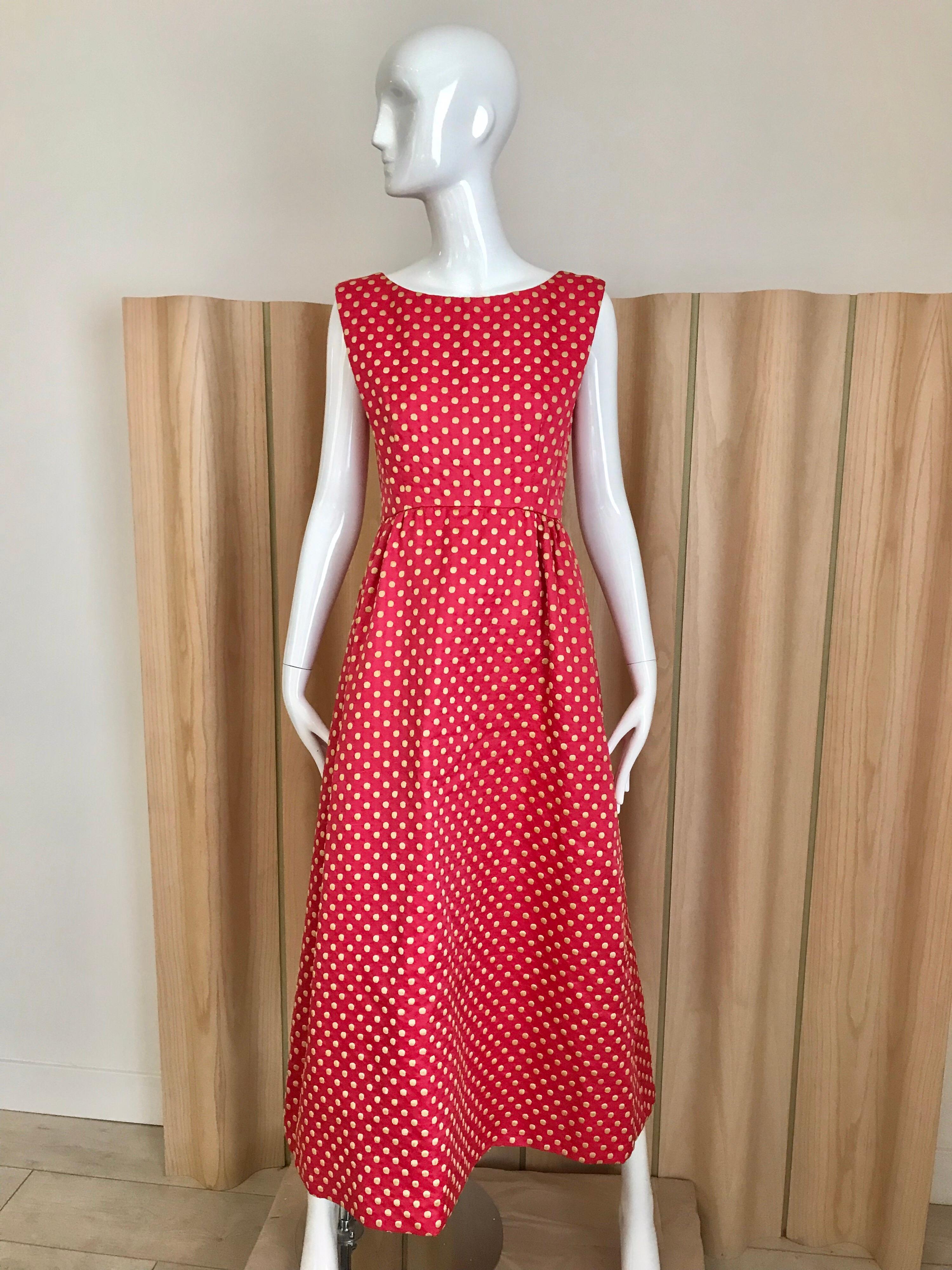 Classic Vintage Norman Norell early 60s sleeveless maxi silk dress in dark pink color with cream polka dots. Dress comes with matching  crop fitted jacket with silk Pom Pom buttons.
Measurement:
Bust: 34 inches / Waist: 28 inches/ Dress length: 50.5