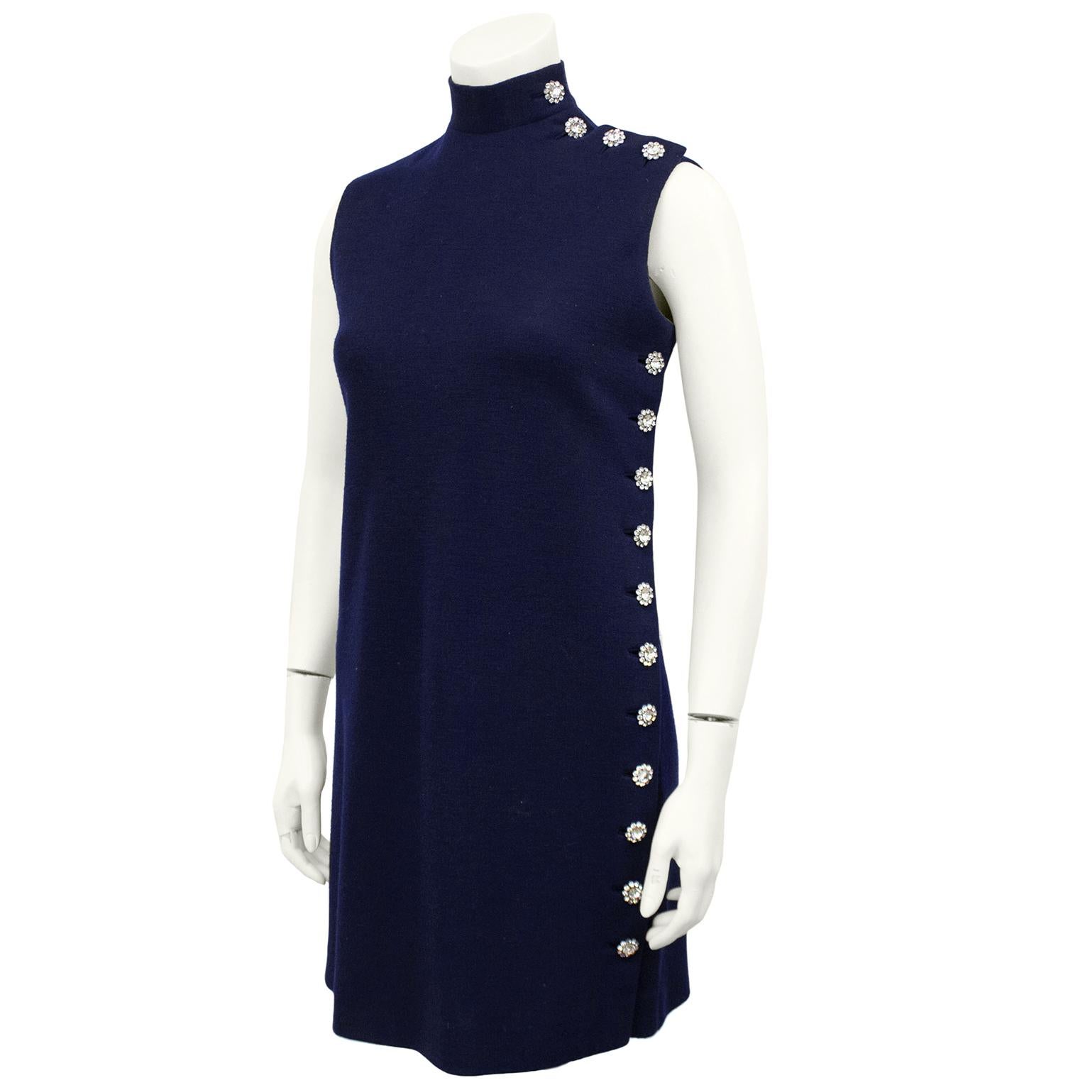 Stunning 1960's Norman Norell sleeveless turtleneck cocktail dress. Navy blue wool jersey with stunning rhinestone flower buttons at the shoulder and down the left side wearing. Subtle with the perfect amount of sparkle. Shift shape. Amazing with