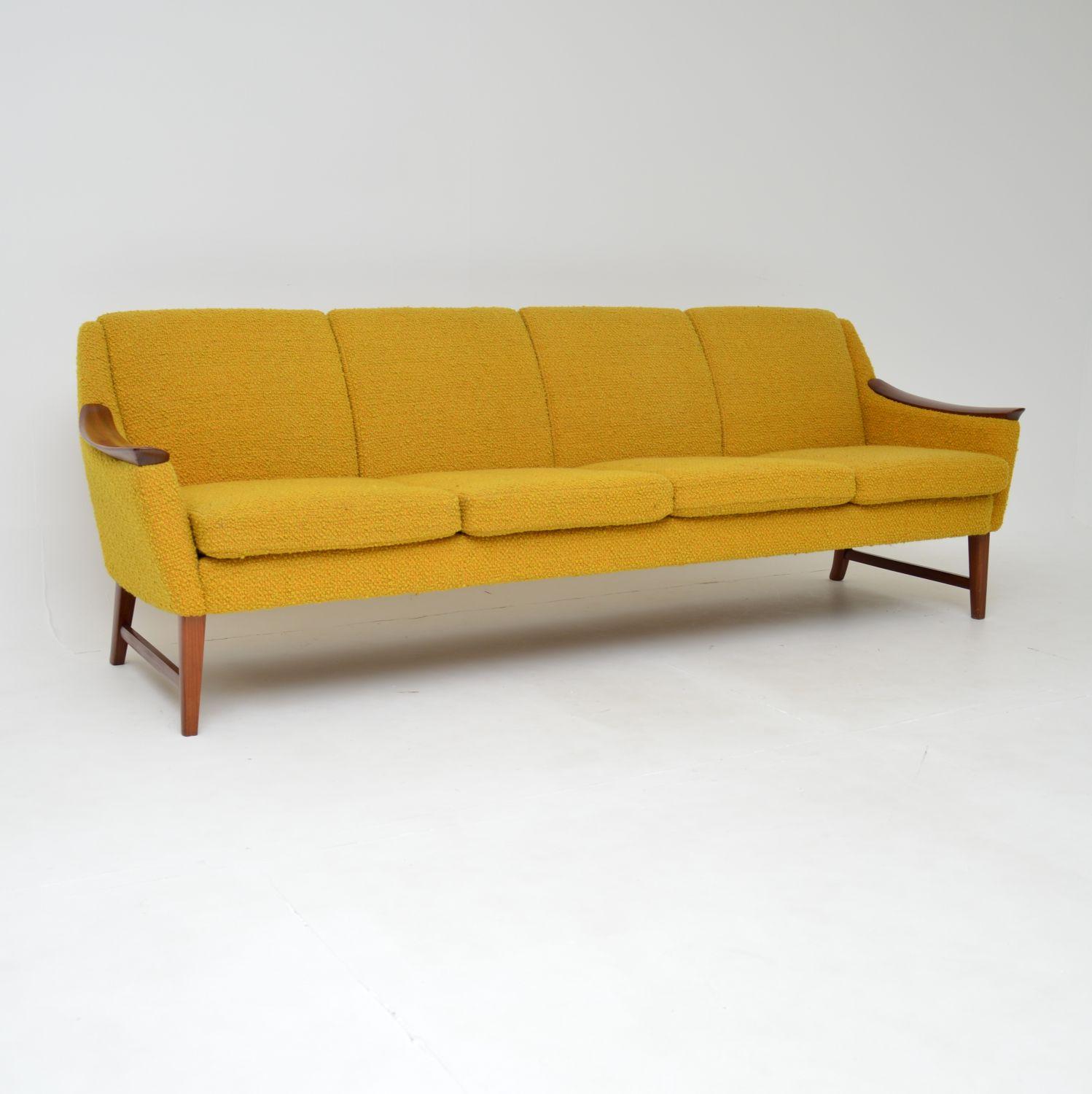 A stunning and very comfortable vintage four seat sofa with a solid teak frame and original yellow boucle wool upholstery. This was made in Norway, it dates from around the 1960-70’s.

This is in spectacular original condition, the yellow boucle is