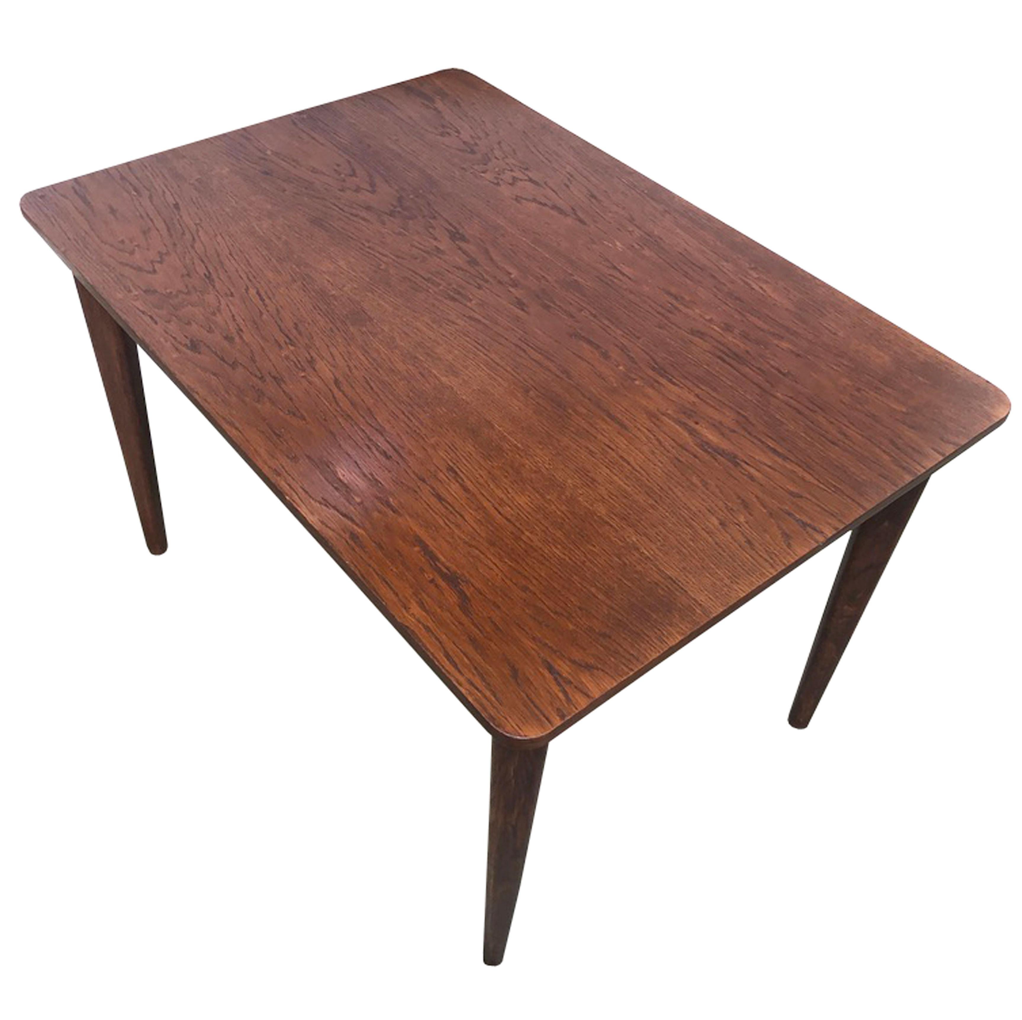 An original Mid Century dining table produced by UP Zavody, Czechoslovakia in 1963.

The table has been designed with elegant proportions and a careful attention to detail; gently curved corners and legs, precise joinery and a beautiful dark colour