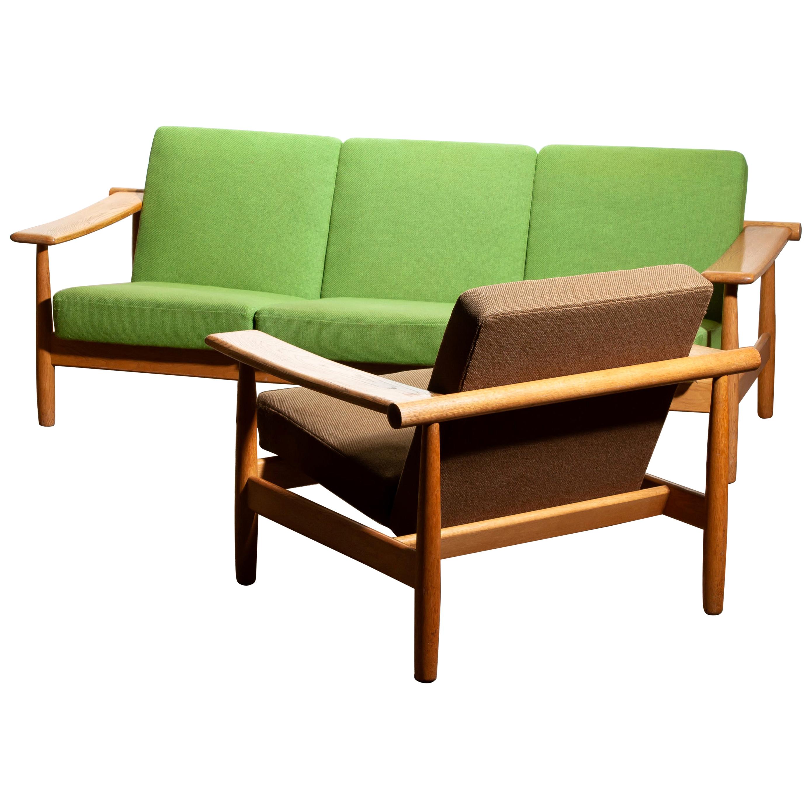 Beautiful oak sofa and lounge chair or living room set from the 1960s, made in Denmark.
The oak frames are in good condition.
The fabric is in fair condition like the pictures shows.
Beautiful set!