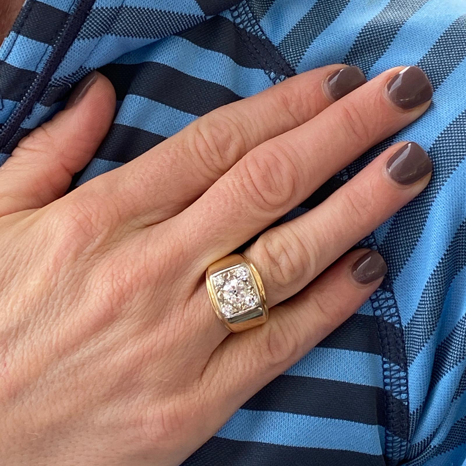 Vintage Old European cut diamond ring fashioned in 14 karat yellow gold. The ring features an Old European cut center diamond weighing .95 carats and another 4 surrounding diamonds weighing ,40 carat total weight. The diamonds are graded G-H color