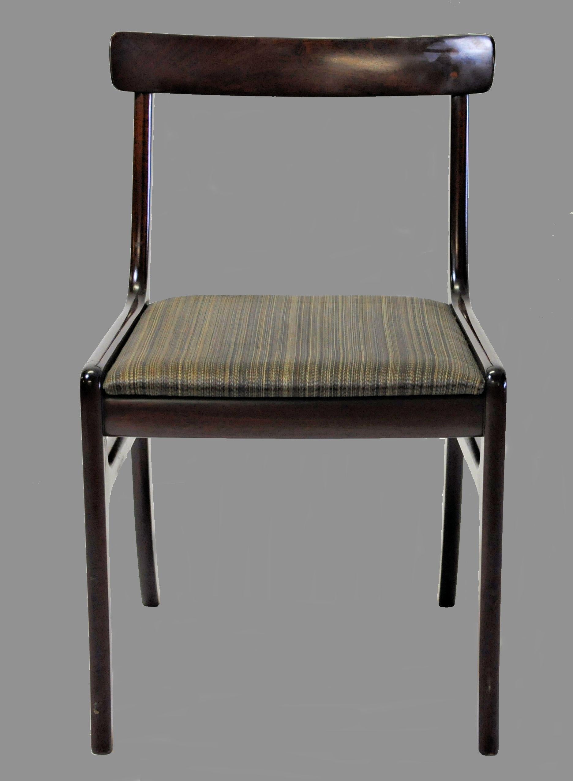 This set of eight mahogany Rungstedlund dining chairs designed by Ole Wanscher were produced during the 1960s and 1970s by Poul Jeppesen Furniture. 

The dining chairs are part of the Rungstedlund dining furniture series designed by Ole Wanscher and