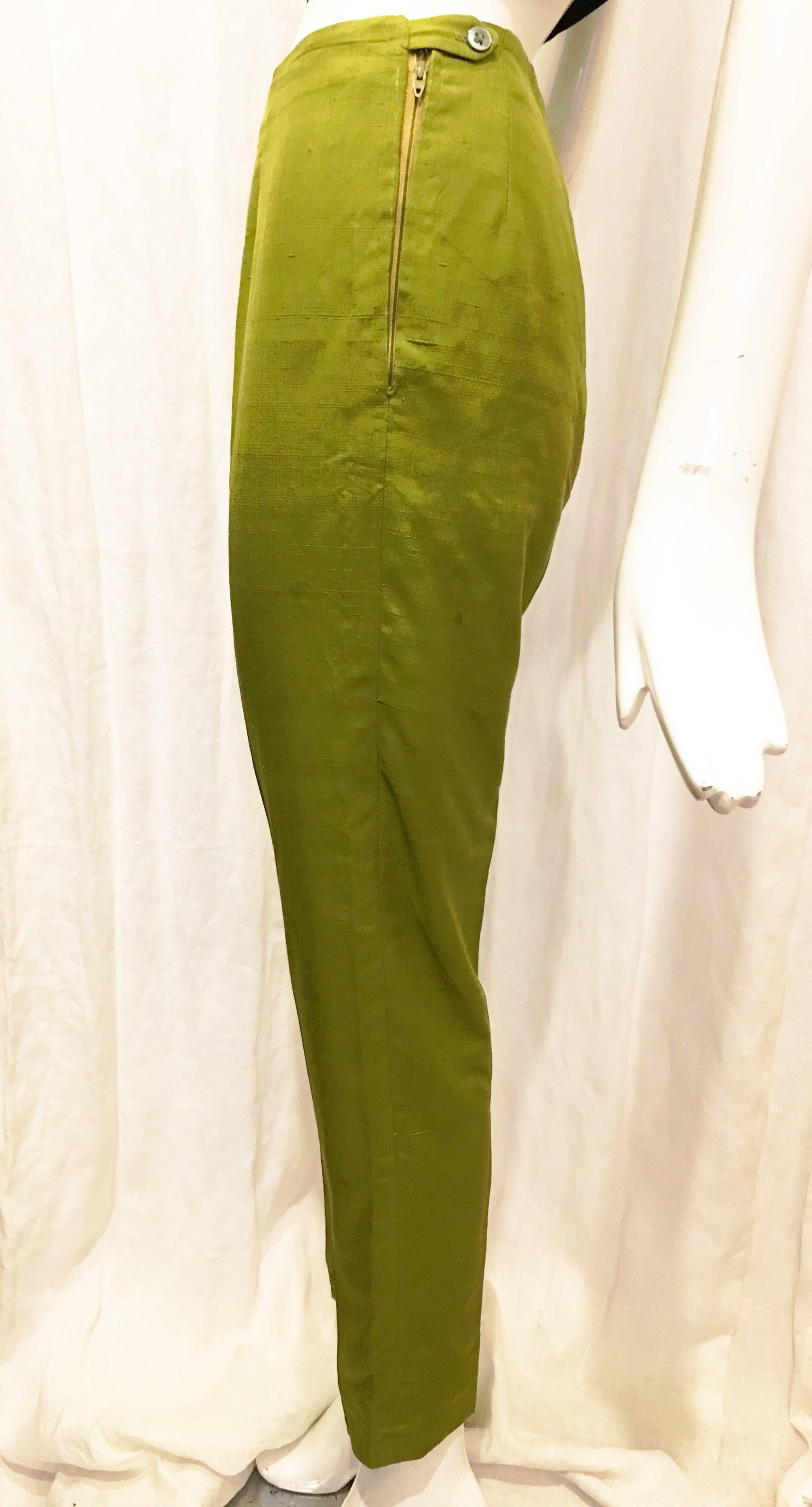 Lime green pleated linen slacks from Oleg Cassini. Hit above the ankle and rise to natural waist. No pockets. Hand sewn lace trim on inside of hem. Small pulls at fabric but nothing notable. Pants zip and button at left hip. Add a pop of color to