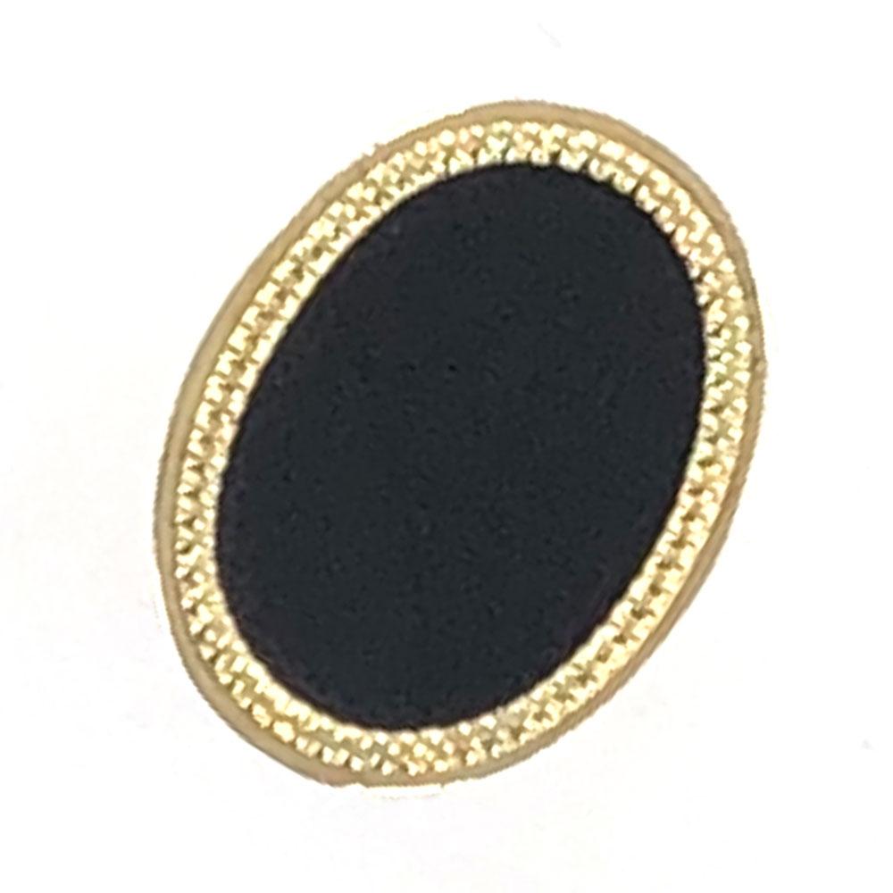1960's onyx oval cocktail ring is fashioned in 18 karat yellow gold. The textured gold surrounds a smooth flat onyx center. The ring measures 25 x 33mm and is currently size 5.75 (can be sized). 