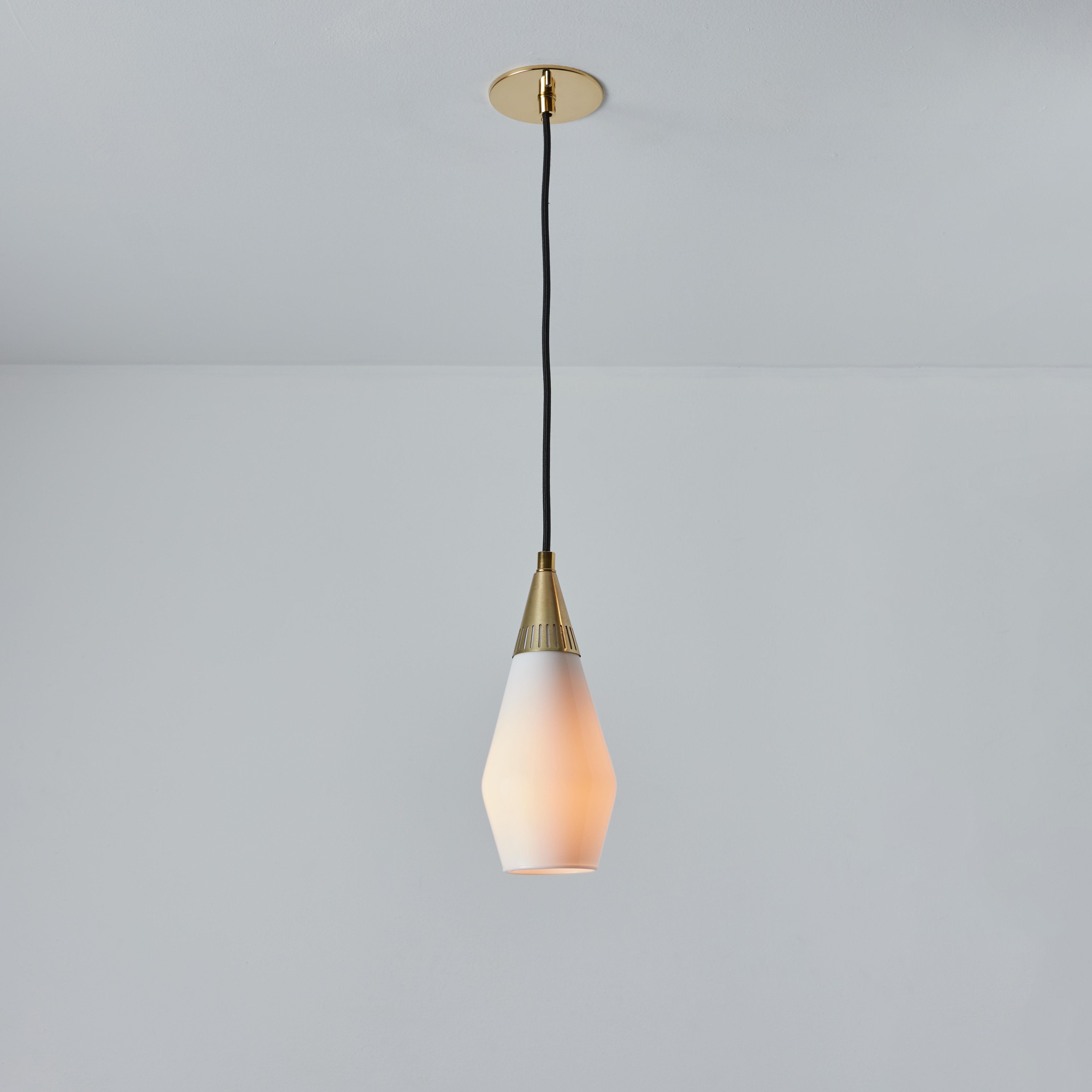 1960s Opaline glass and brass geometric pendant lamp attributed to Mauri Almari. Executed in glossy opaline glass and brass with black cloth cord and custom fabricated period style brass canopy for mounting over a standard American j-box. Highly