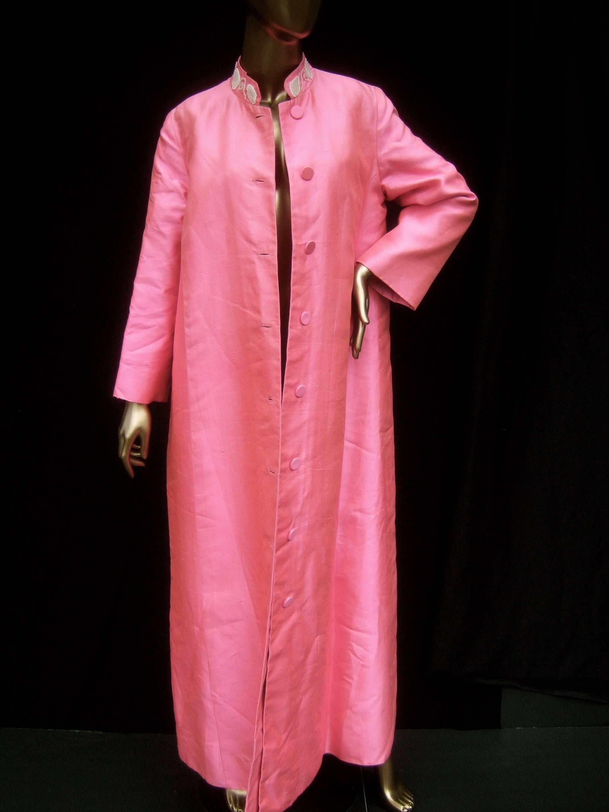 1960s Opulent pink silk shantung opera coat 
The elegant long coat is designed with luminous
bright pink silk shantung fabric

The row of buttons that run down the front are
covered with the same pink silk fabric

The Nehru style stand up collar is