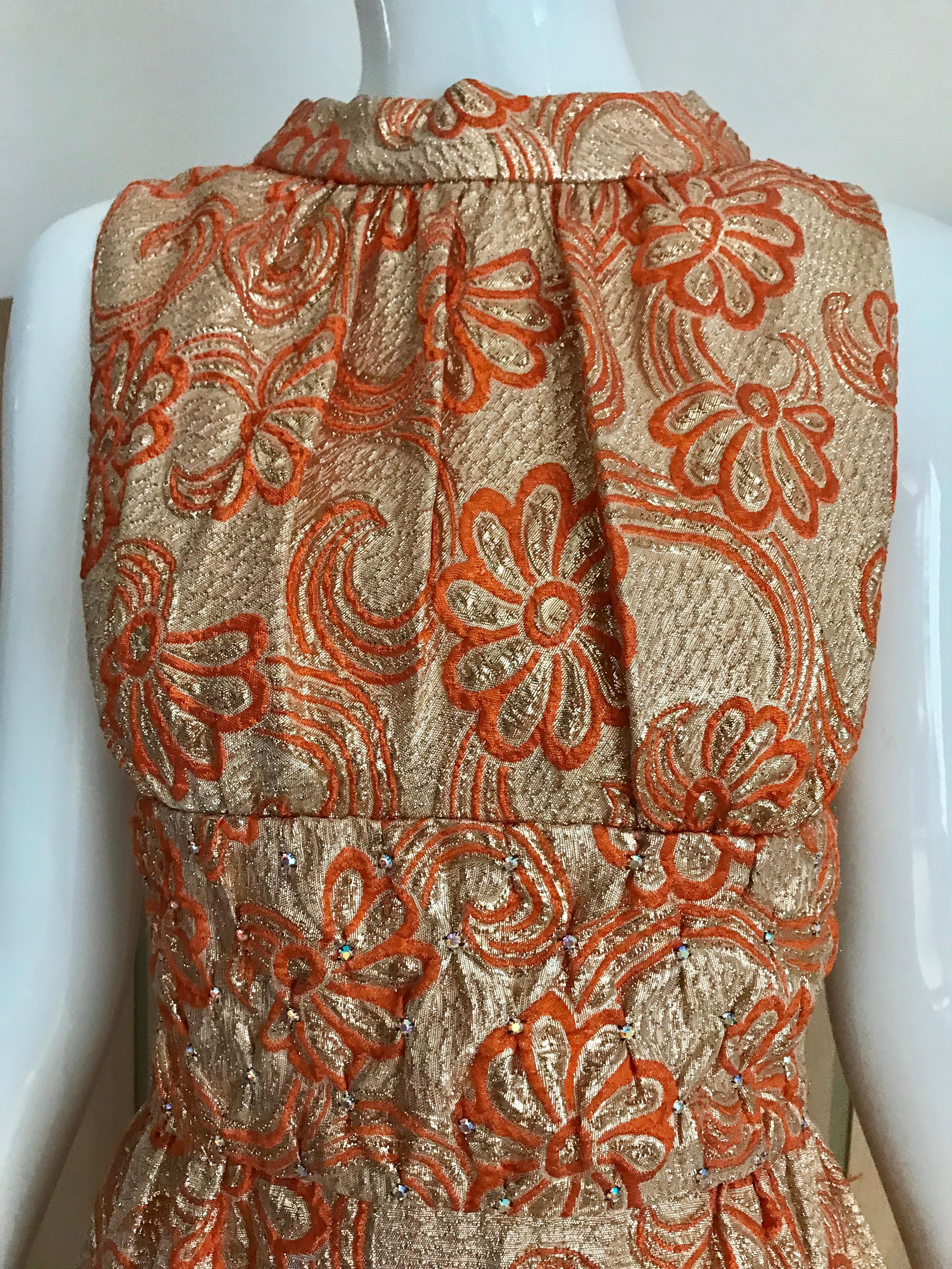 Vintage 1960s Orange and Gold brocade sleeveless maxi evening dress. Dress is lined in cotton.
Size: 4 or small
Bust: 36 inches/ Waist: 26 inches/ Hip: 42 inches/ Dress length: 51 inches