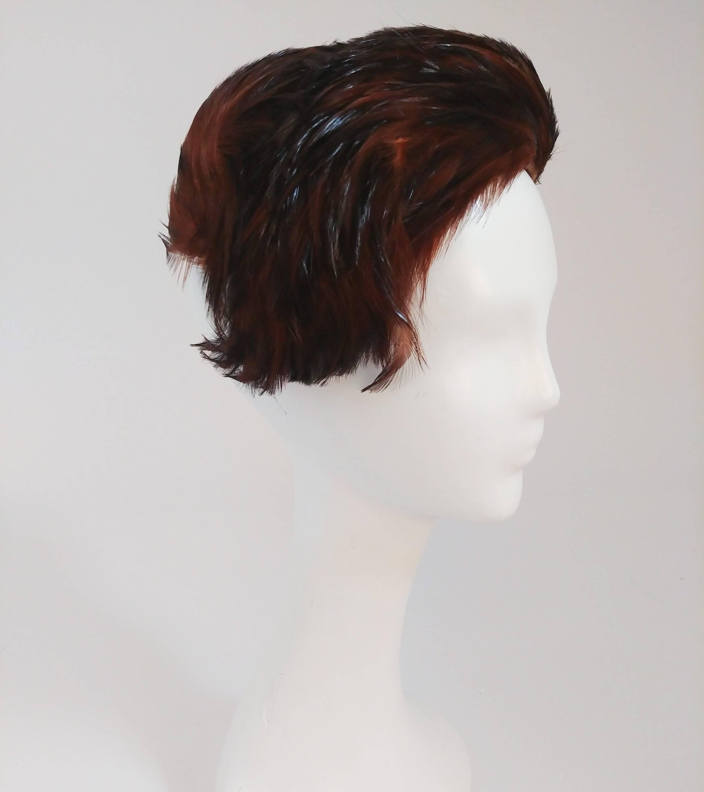 1960s Orange Curled Feather Hat. Cocks asymmetrically to one side. Wear with a hat pin.