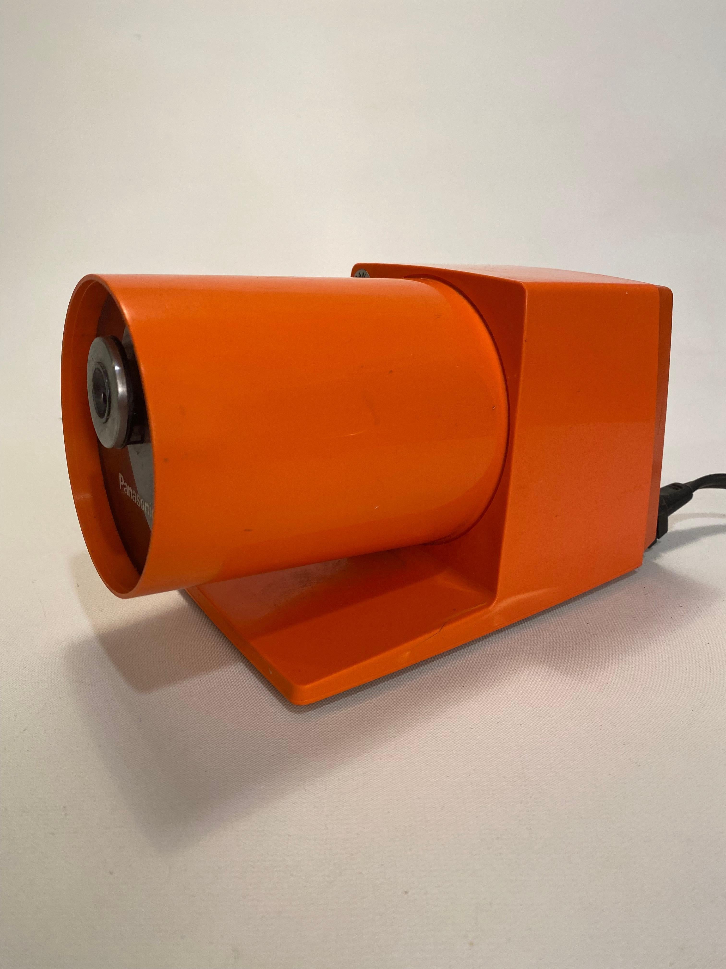 The best desk or table top Mid-Century Modern electric pencil sharpener. The KP-22A model by Panasonic, circa 1965-70. Made in Japan. Modern lines and profile. Sculptural hard plastic bright orange casing with a pull out compartment for the pencil