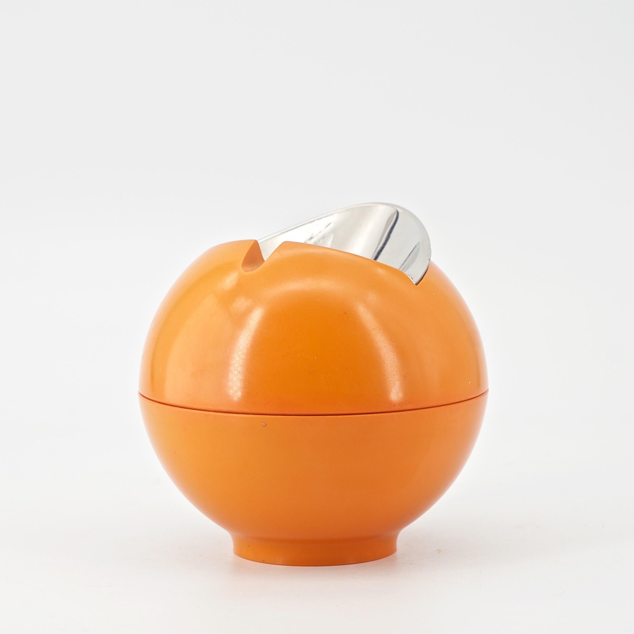 A wonderful sculptural orange orb ashtray from the 1960s German era of ABS Plastics manufacturing dominance. Harder to find and highly collectible decor. Just about 3 1/2 inches wide and tall.
