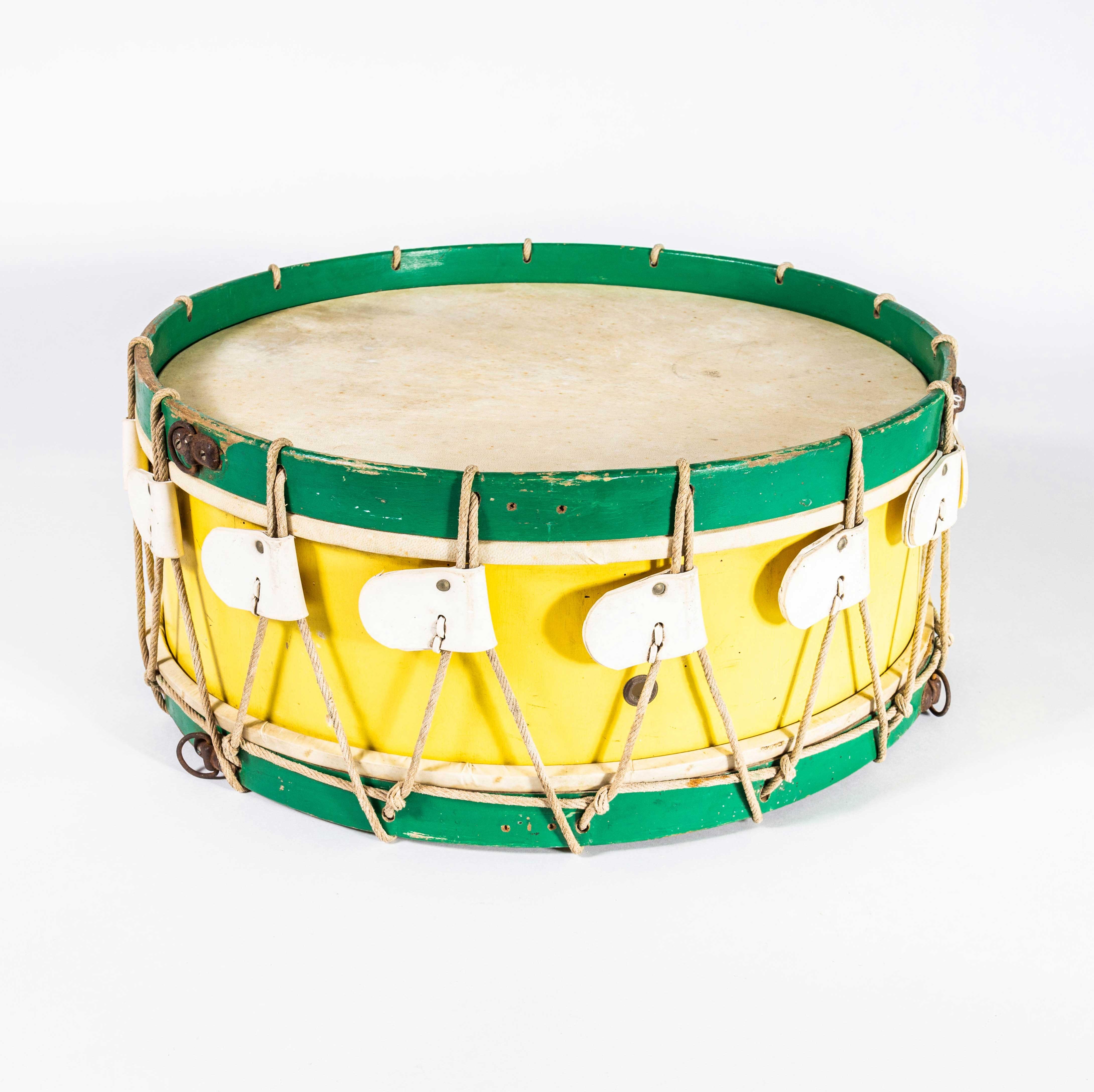 1960's Original Large Working Yellow Drum. 

Original working drum complete with drumsticks. Skin on both sides is reasonably tight but best used as a decorative item although it seems fairly resilient. Do not use as a toy with children as it will