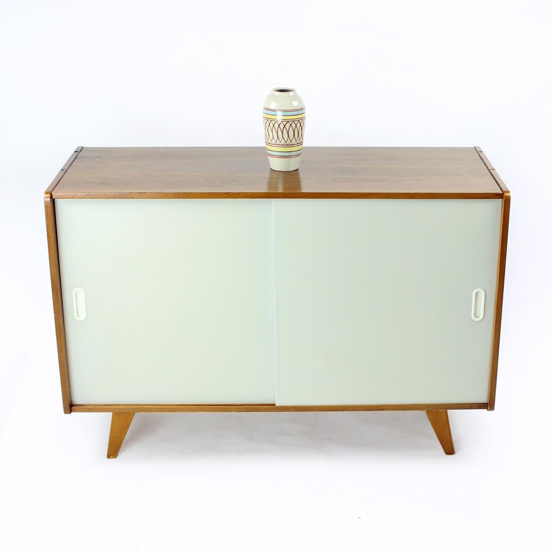Completely restored sideboard with sliding doors. This item was produced in 1960s, in the mid-century design era of Czechoslovakian design. Designed by Jiri Jiroutek for Interier Praha. The sideboard is completely renovated with new finish in dark