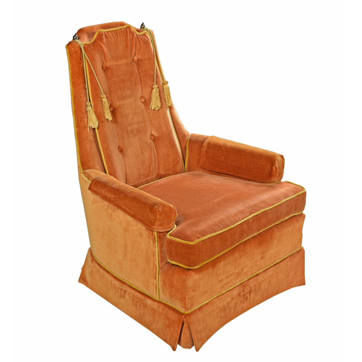 Near mint high back lounge chairs. The peach (yellow orange) velvet velour fabric exemplifies the period. These velvet arm chairs are so citrusy you'll want to bite into them. To top it off, they're embellished with gold piping and tassels tied to